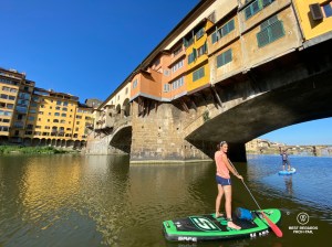 Writer Marcella van Alphen stand up paddling the Arno River by the Ponte Vecchio in Florence, Italy.