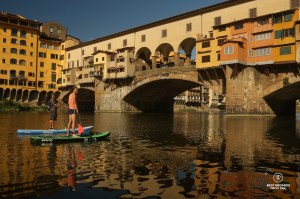 Stand up paddling the Arno River by the Ponte Vecchio in Florence, Italy