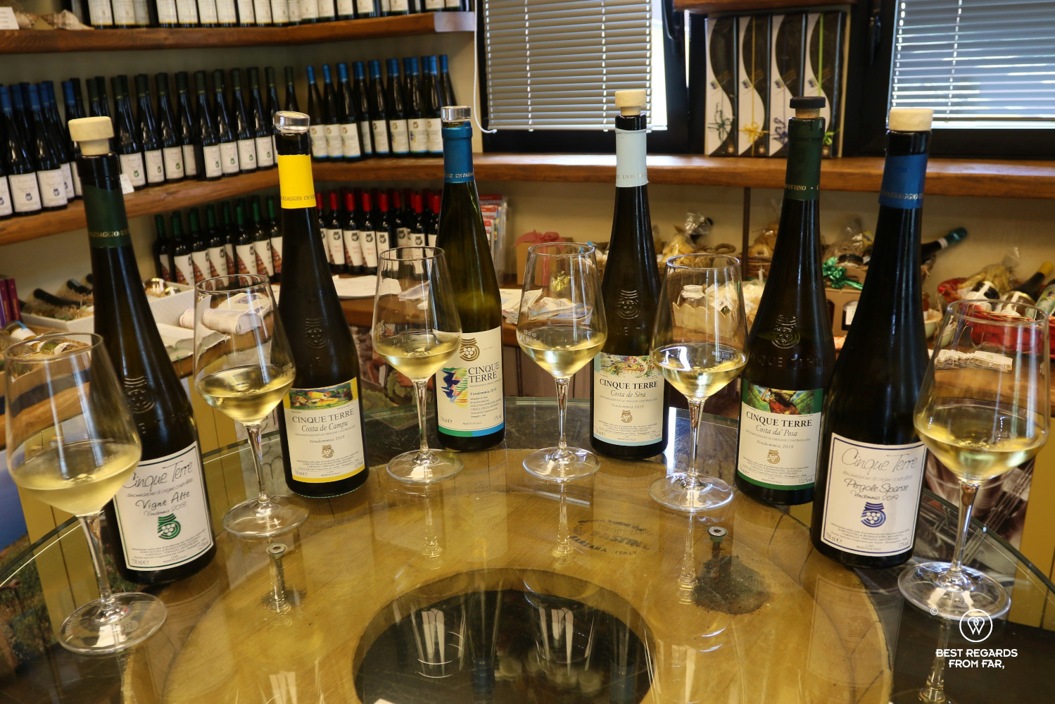 Six bottles of Cinque Terre white wines with six glasses of white wine