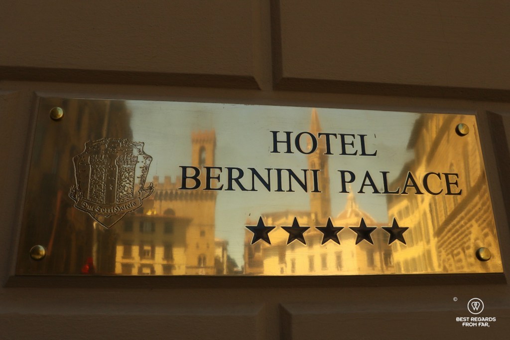 Golden plate of hte Hotel Bernini Palace reflecting the Palazzo Vecchio and the Duomo, Florence, Italy.