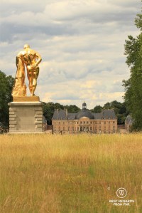 The castle of Vaux le Vicomte seen from the French garden with the golden sculpture of Hercule