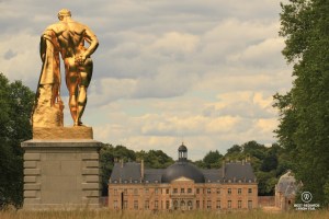 The castle of Vaux le Vicomte seen from the French garden with the golden sculpture of Hercule.