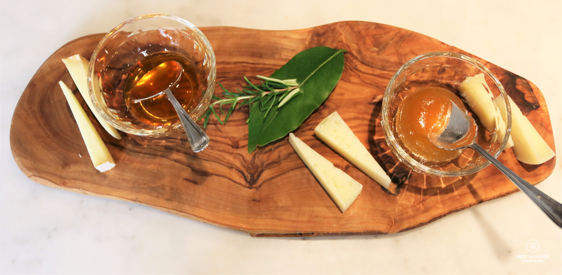 Three types of Italian Pecorino cheese served on a wooden board with honey and mustard