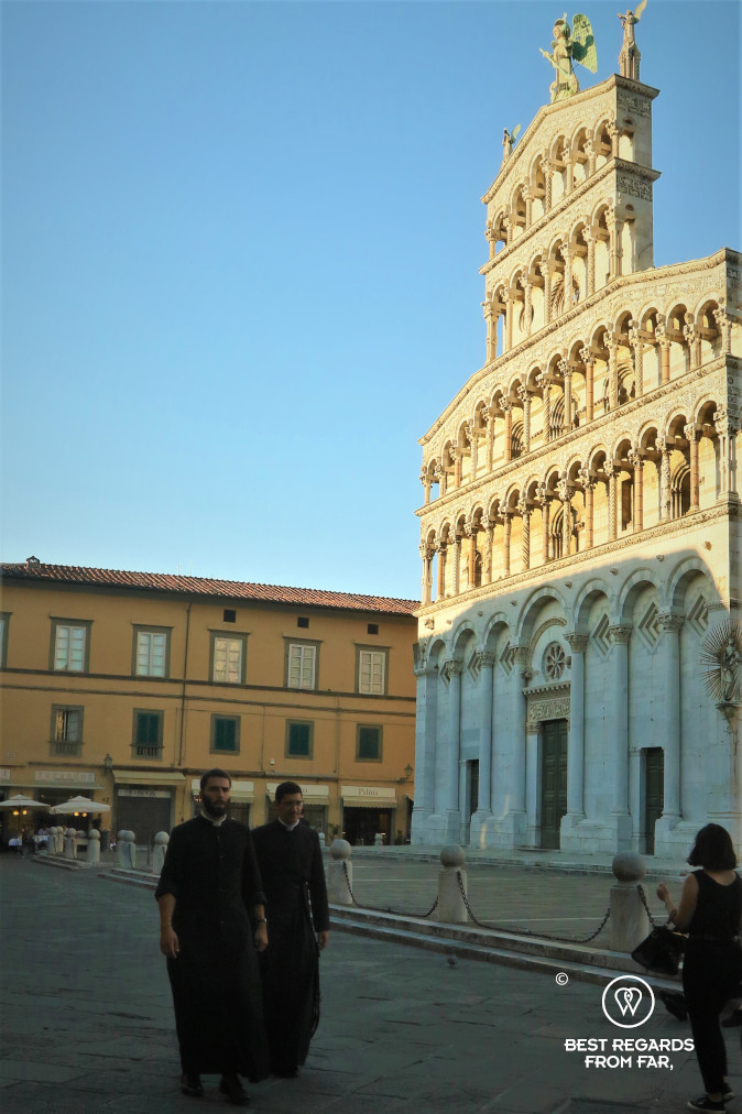 Priests in front of the Saint Michael church in Lucca, Italy