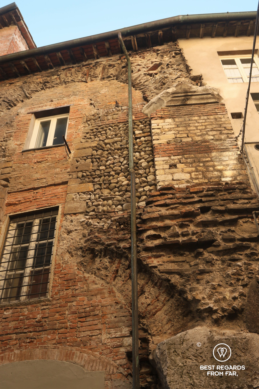 Old stones of a house in Lucca, Italy