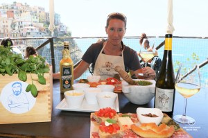 Tasting the pesto with bites and local wine after the pesto workshop at Nessun Dorma with a stunning view on the village of Manarola, Cinque Terre, Italy