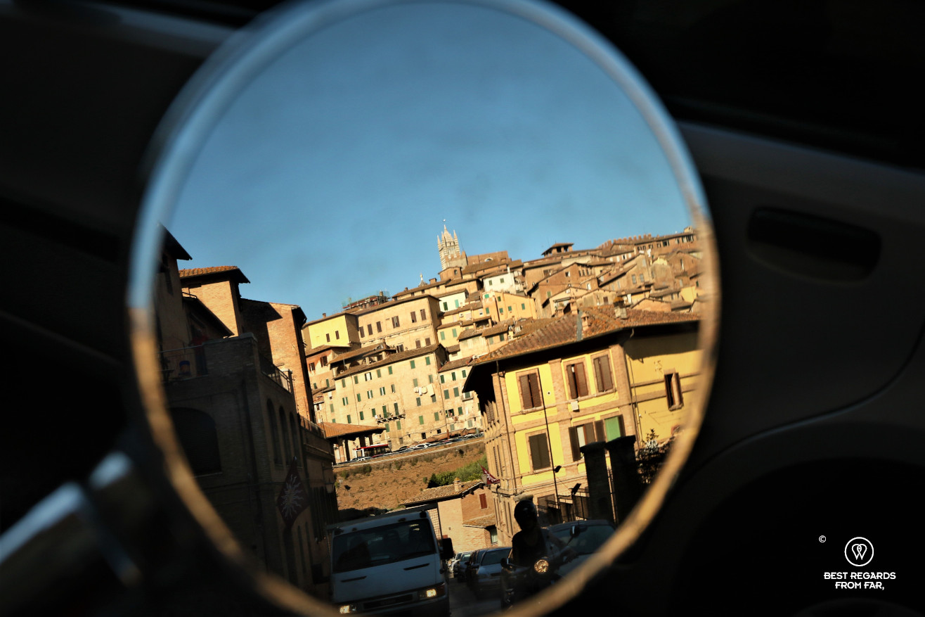 Reflection of Siena in the mirror of a scooter, Italy