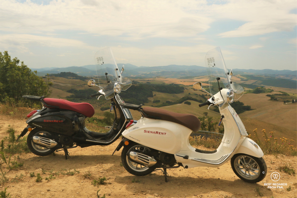Two Vespa scooters overlooking the Tuscan landscape, Italy