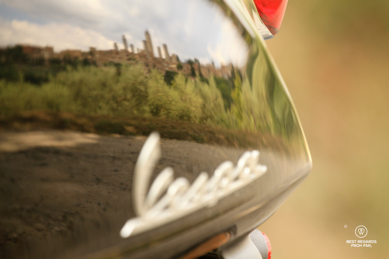 Reflection of the towers of San Gimignano on a Vespa scooter, Tuscany, Italy