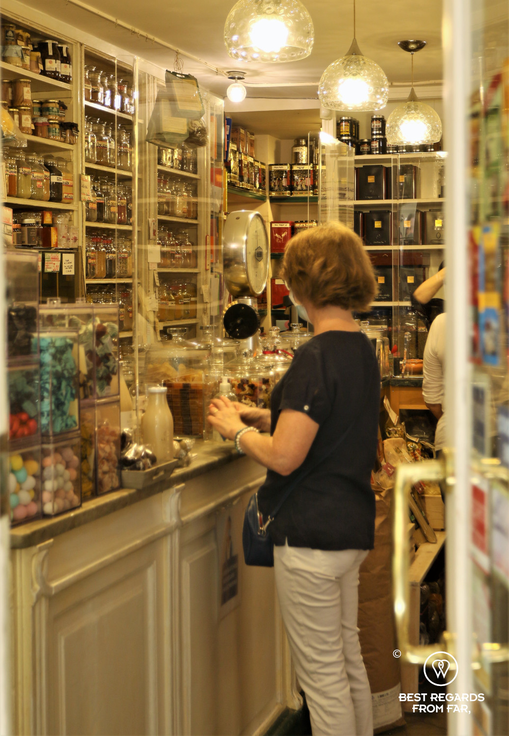 Woman buying spices in an old spice store in Genoa, Italy