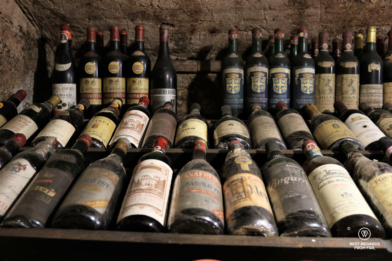 Old bottles of aged red wine in a brick cellar in Lucca, Italy