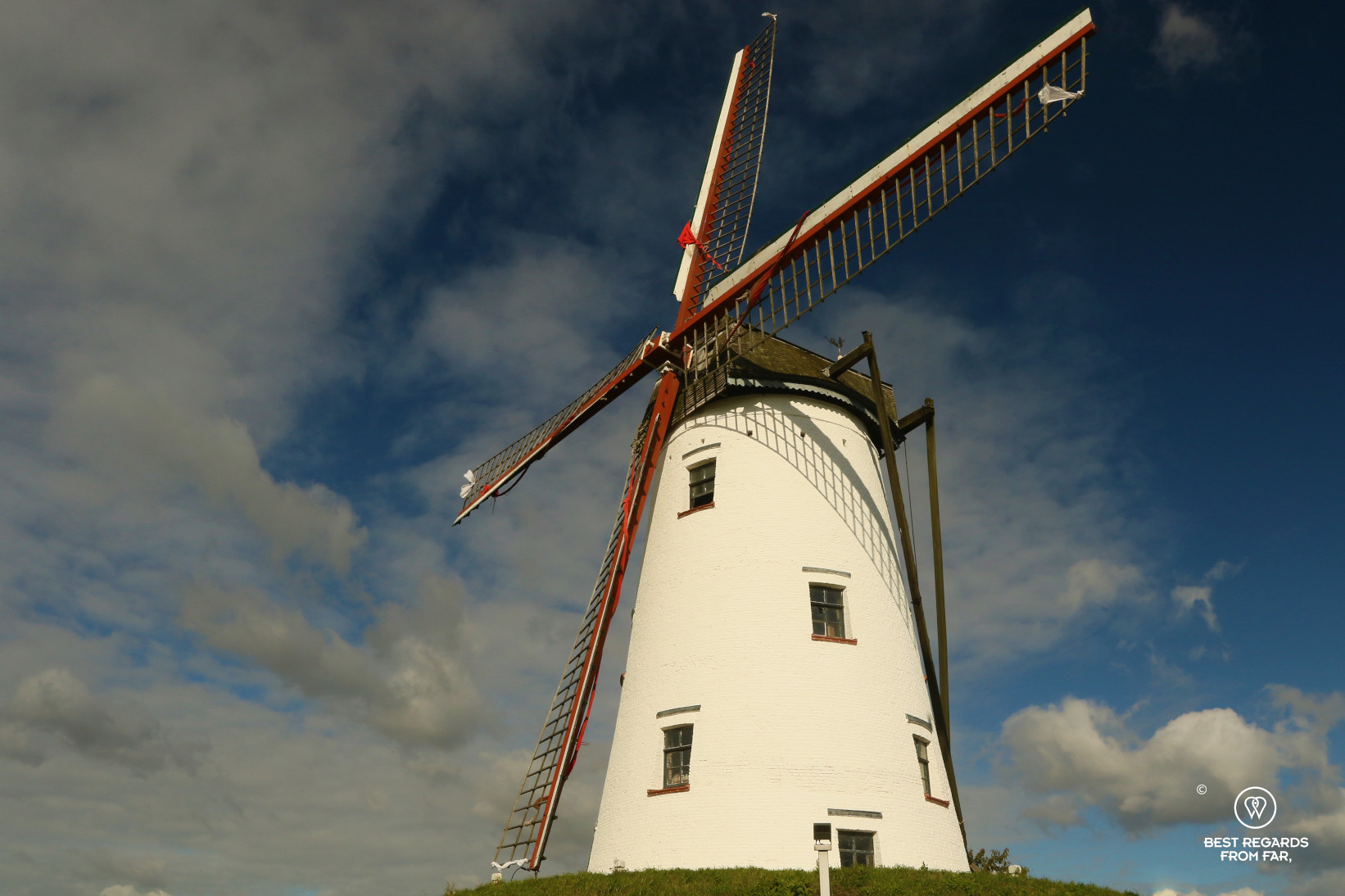 Biking from Bruges to Damme and passing by a traditional windmill, Belgium