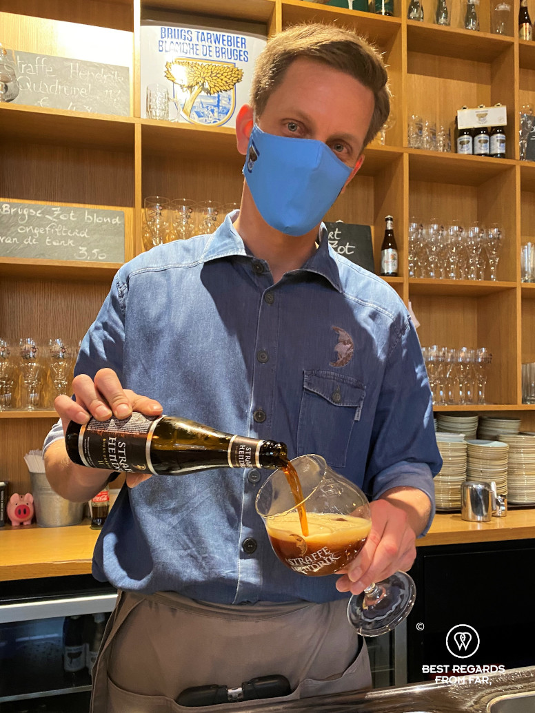 Bartender pouring a beer at De Halve Maan brewery pub, Bruges, Belgium