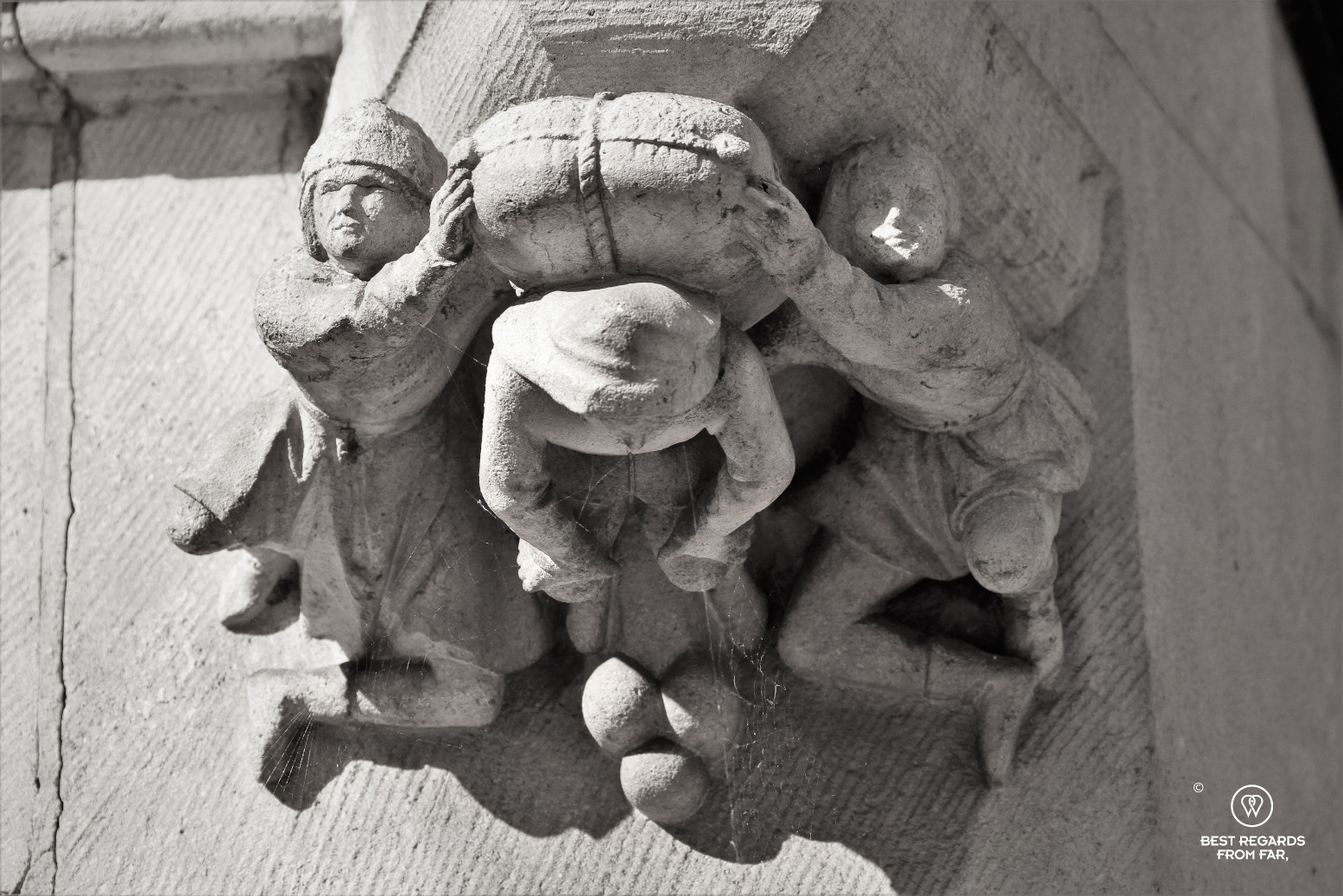 Detail on a building showing how cargo was carried during medieval times in Bruges