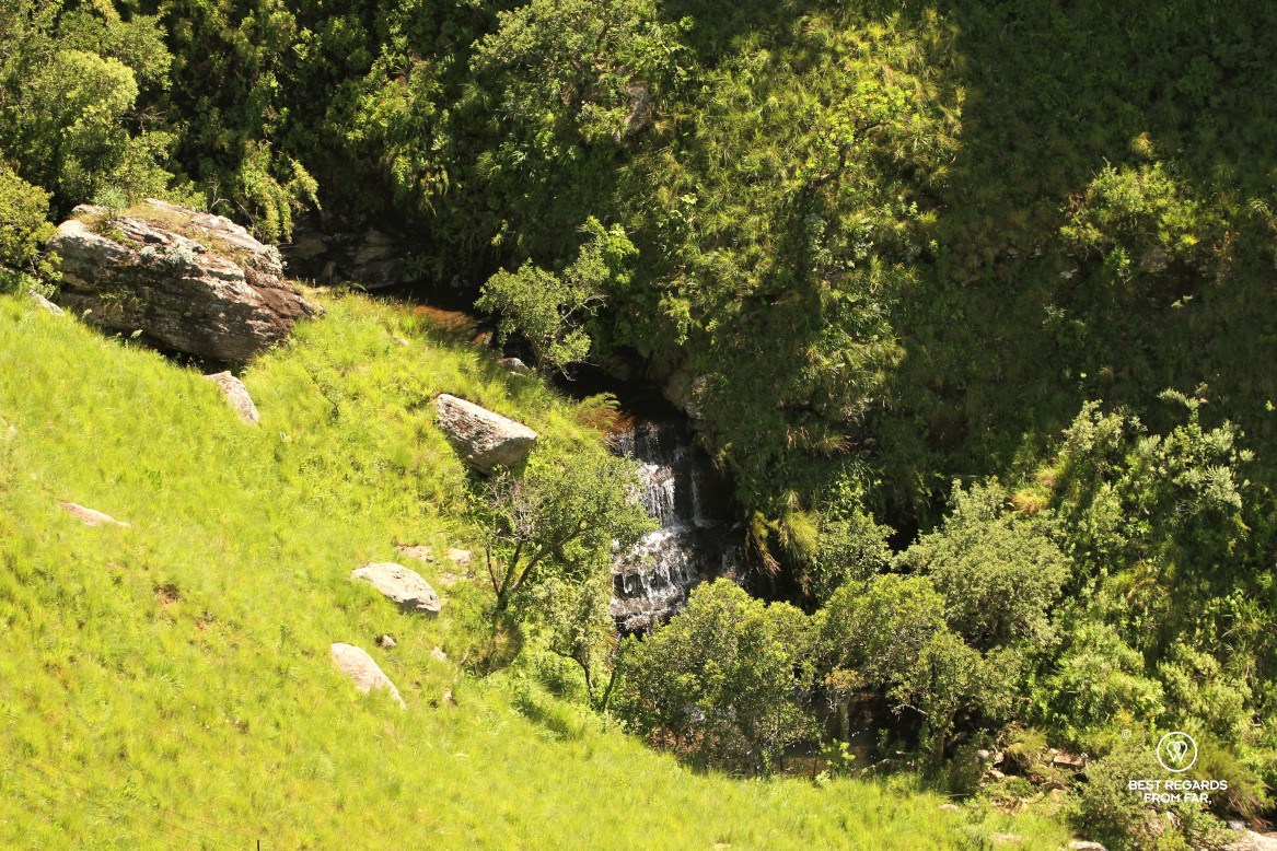 Waterfall amongst green mountain slopes, Drakensberg, South Africa