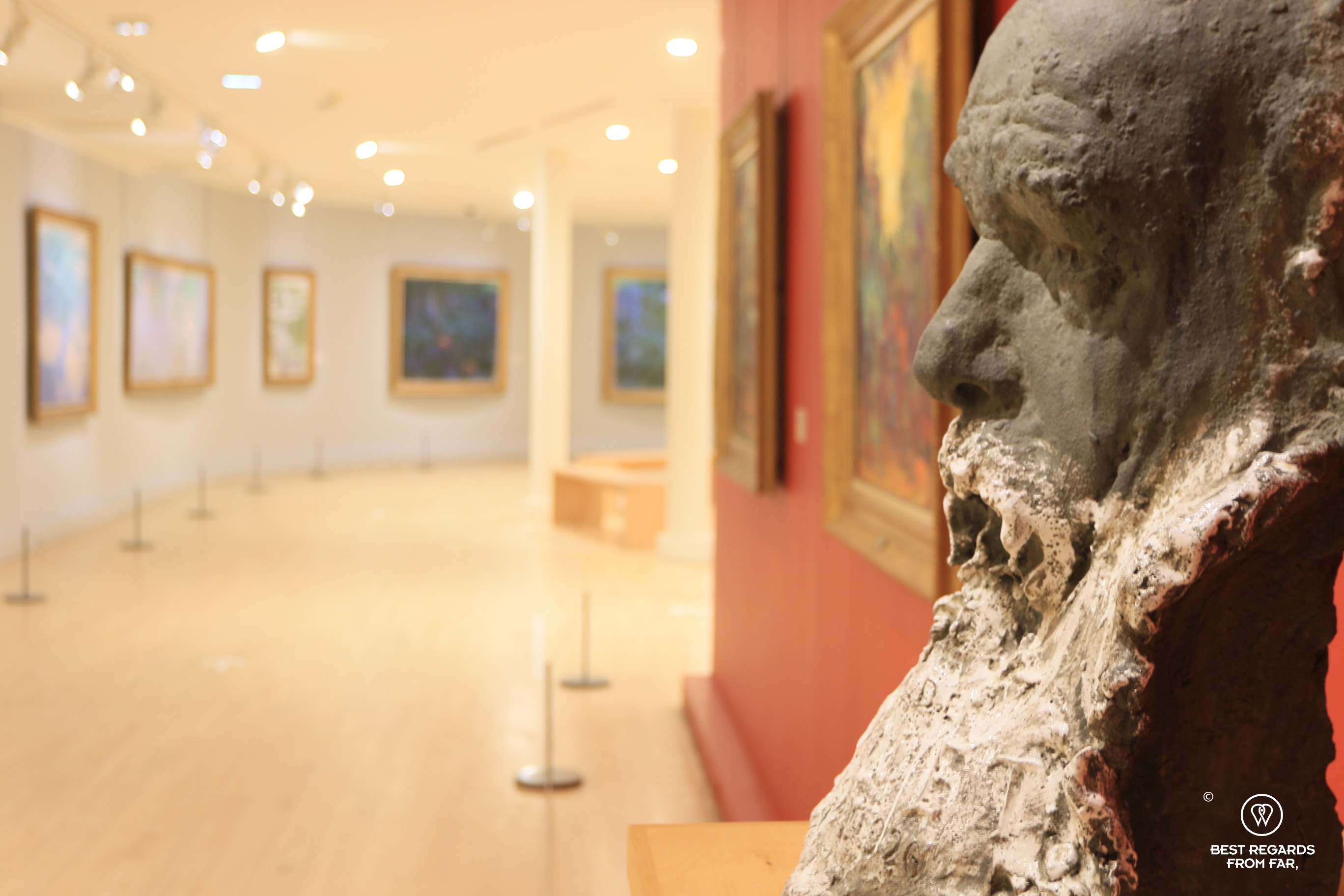 Bust of Claude Monet looking at the Monet room at Musée Marmottan Monet, Paris
