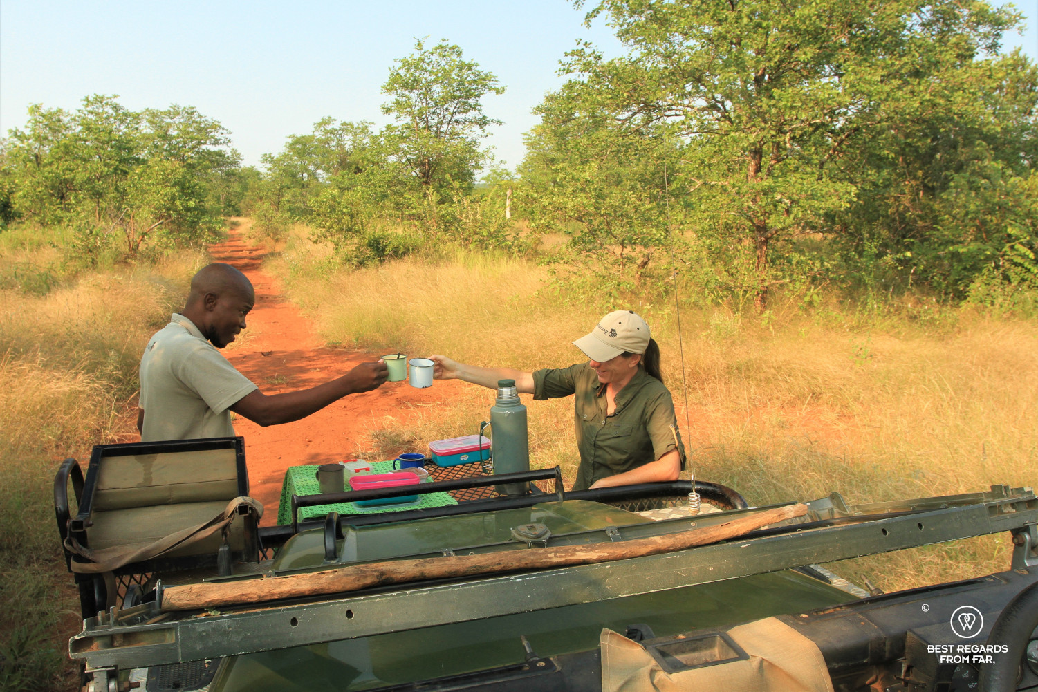 Author Claire Lessiau cheering with EcoTracker instructor Norman Chauke by the Land Rover