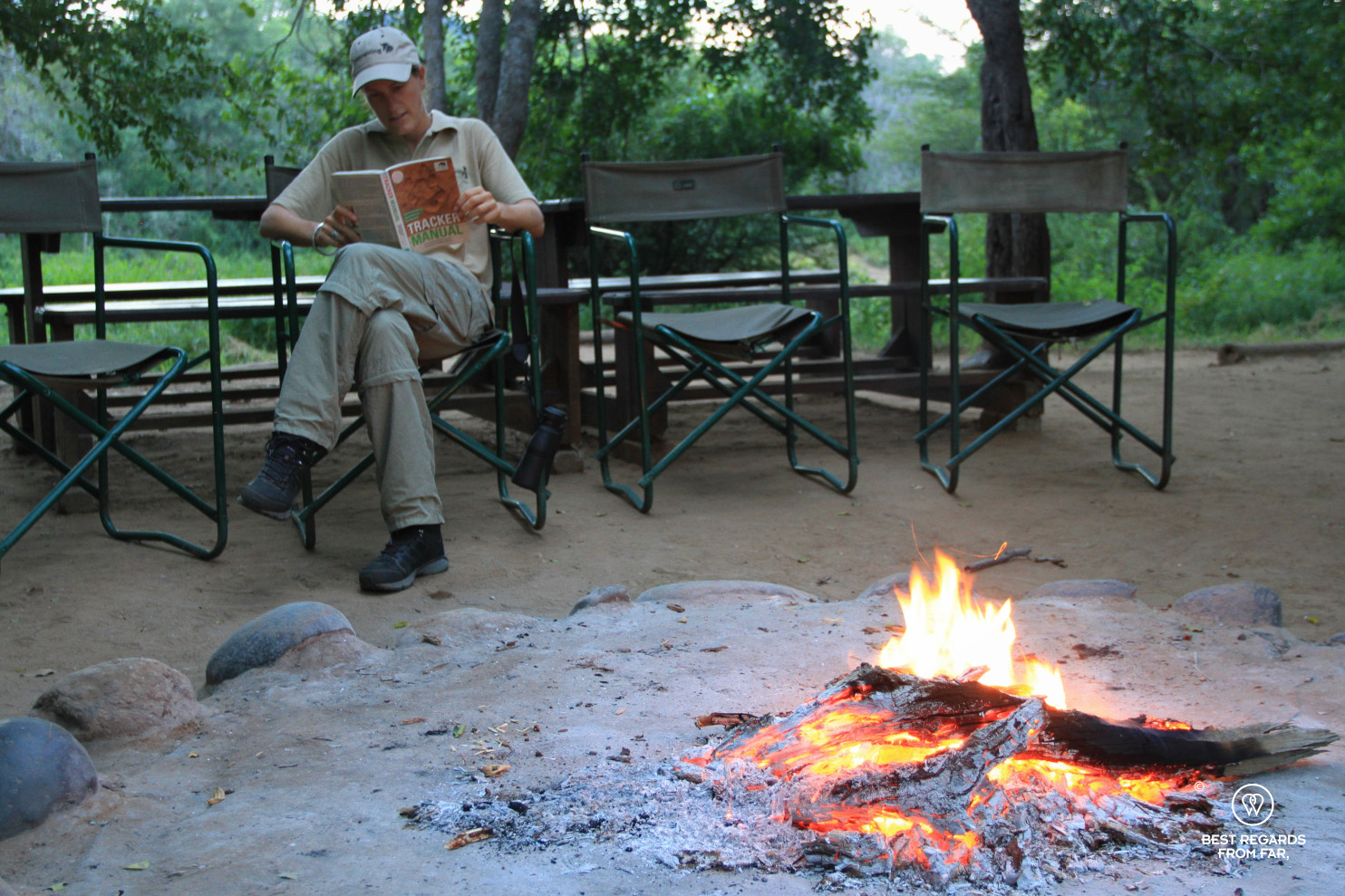 Photographer Marcella van Alphen studying the theory of tracking at the Selati camp by the fire