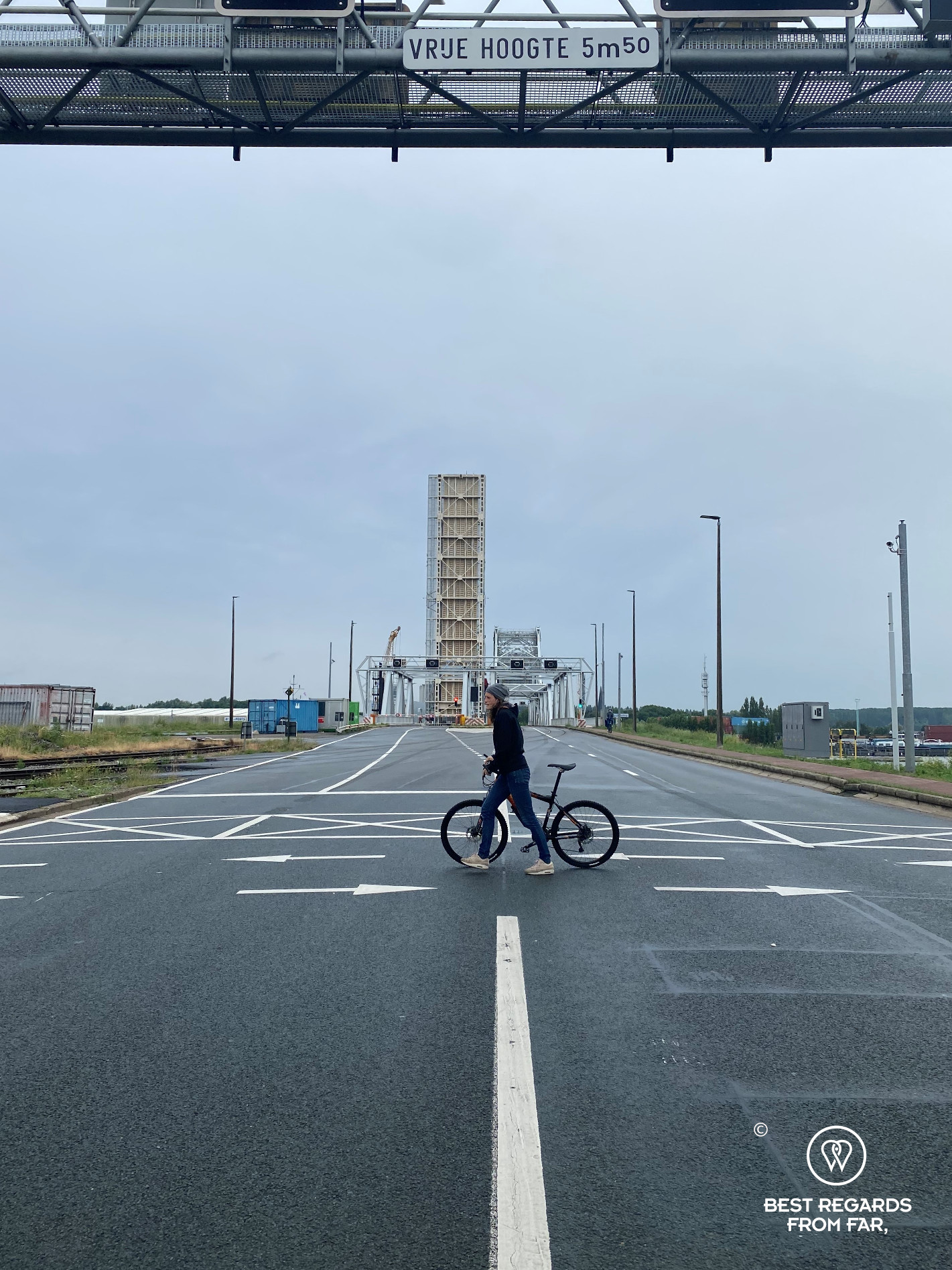 Biker crossing a road in the industrial harbour of Antwerp, Belgium