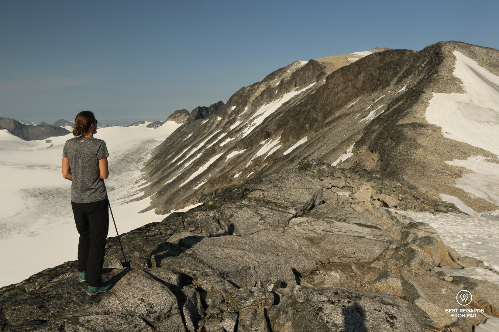 Woman in t-shirt on the rocky trail ascending Norway's highest mountain in Jotunheimen NP