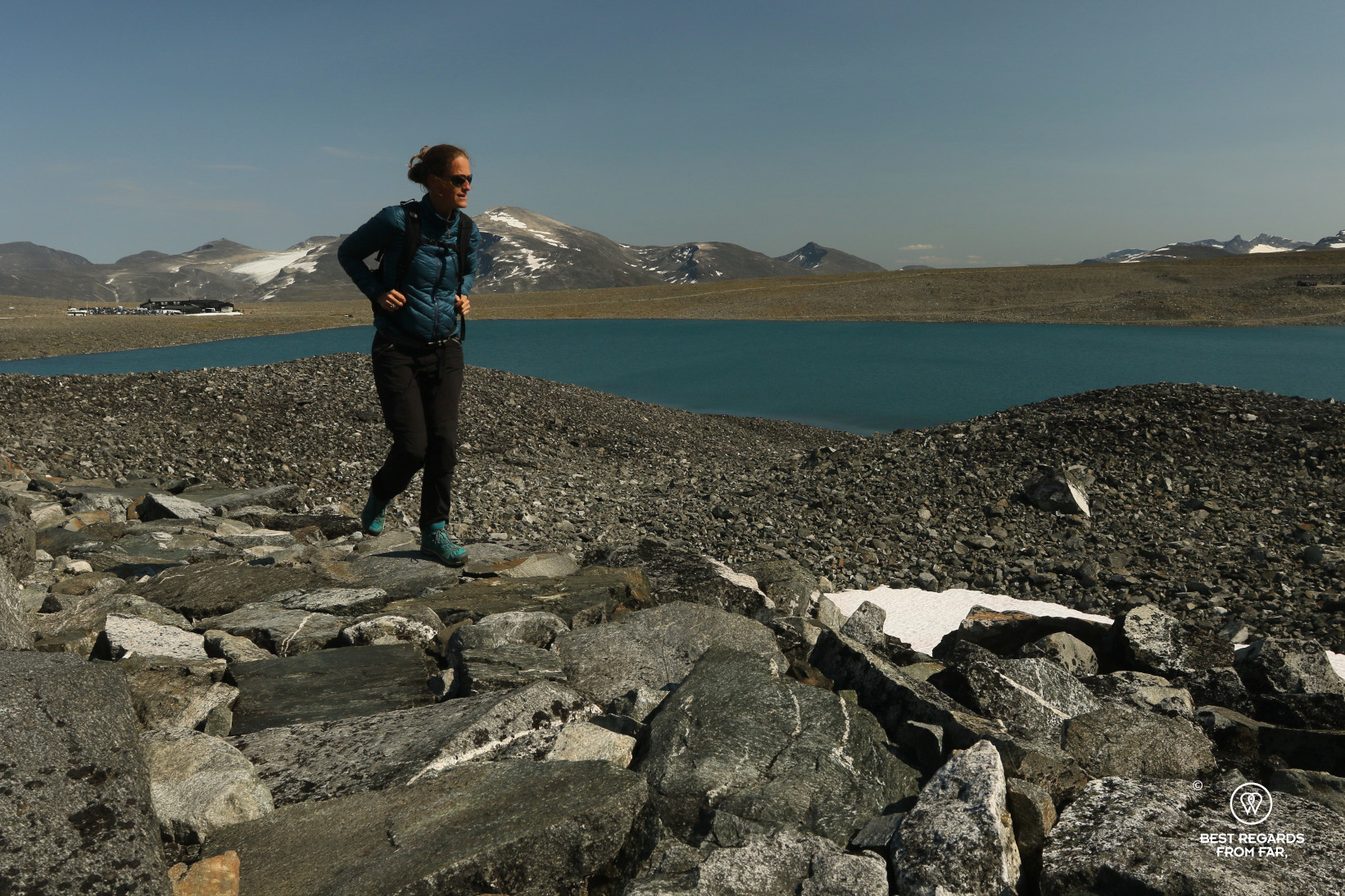 Author Marcella van Alphen walking along a glacier lake, Norway
