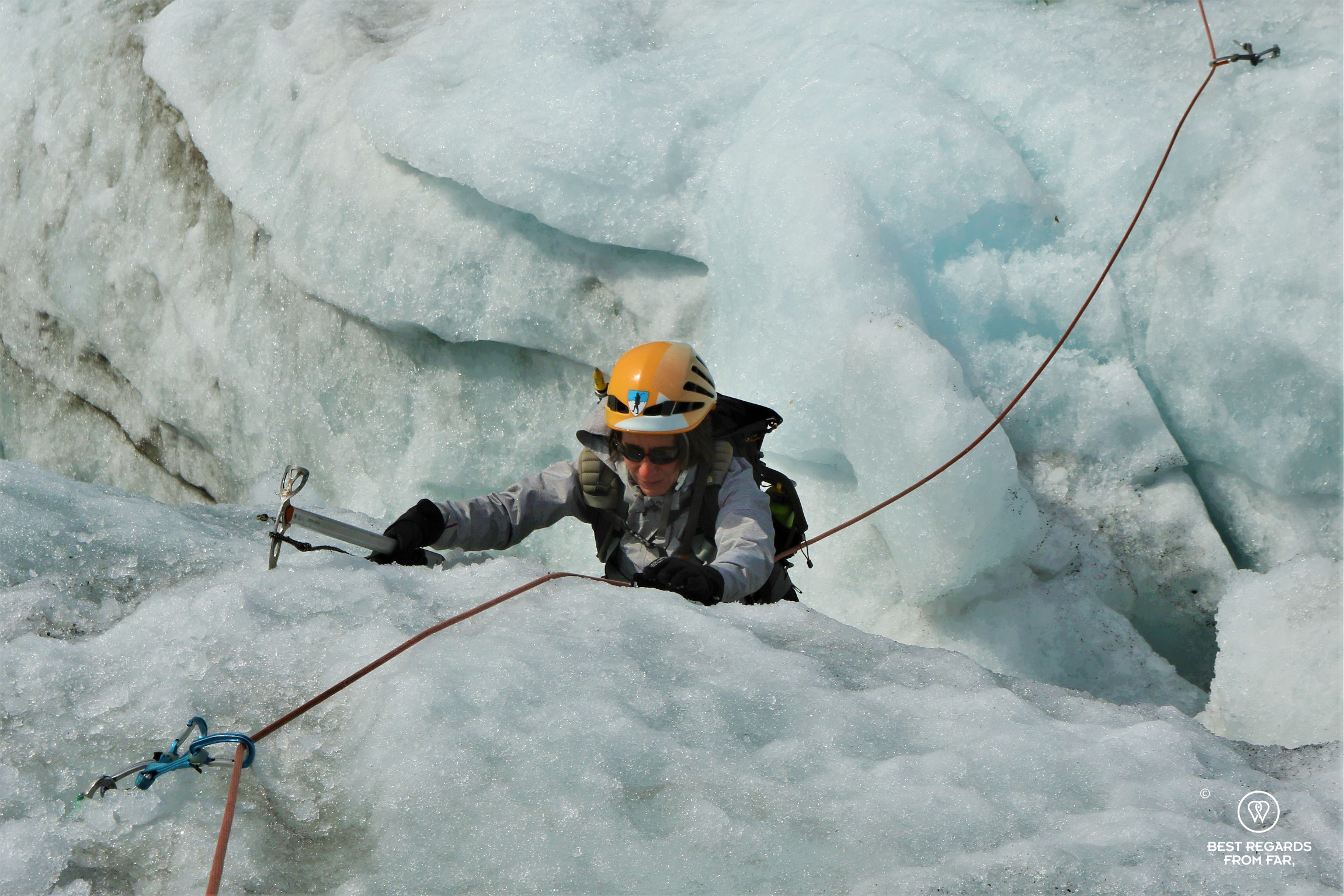 Photographer Claire Lessiau climbing out of a crevasse on the Fonna Glacier