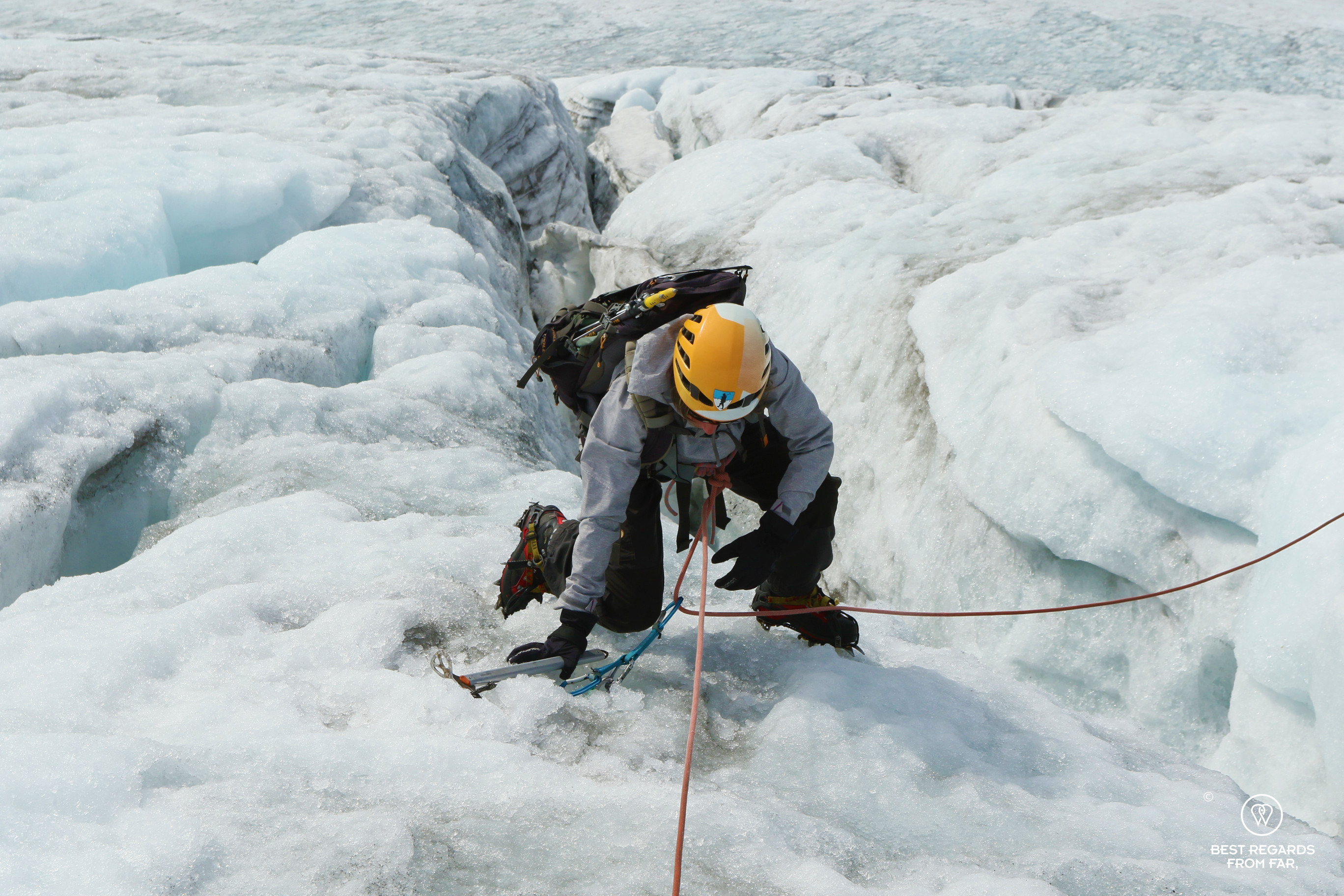 Photographer Claire Lessiau climbing out of a crevasse on the Fonna Glacier