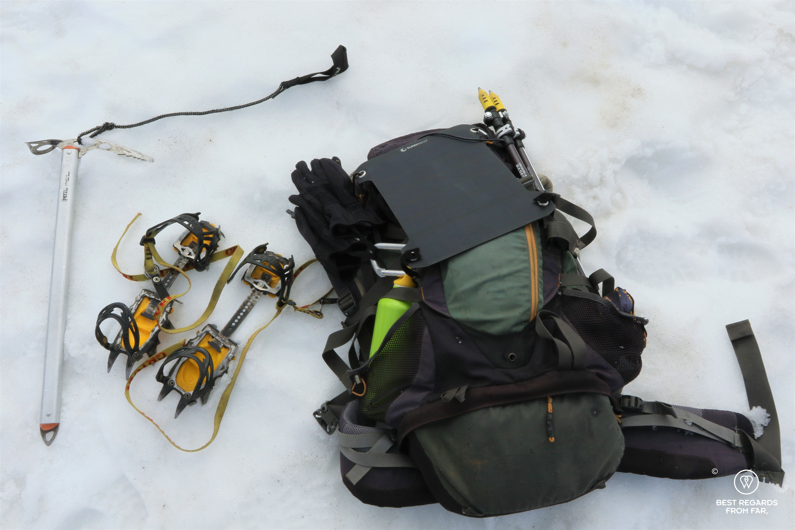 Gear with ice axe, crampons, SunnyBag solar panel, hiking poles and back pack for glacier hiking