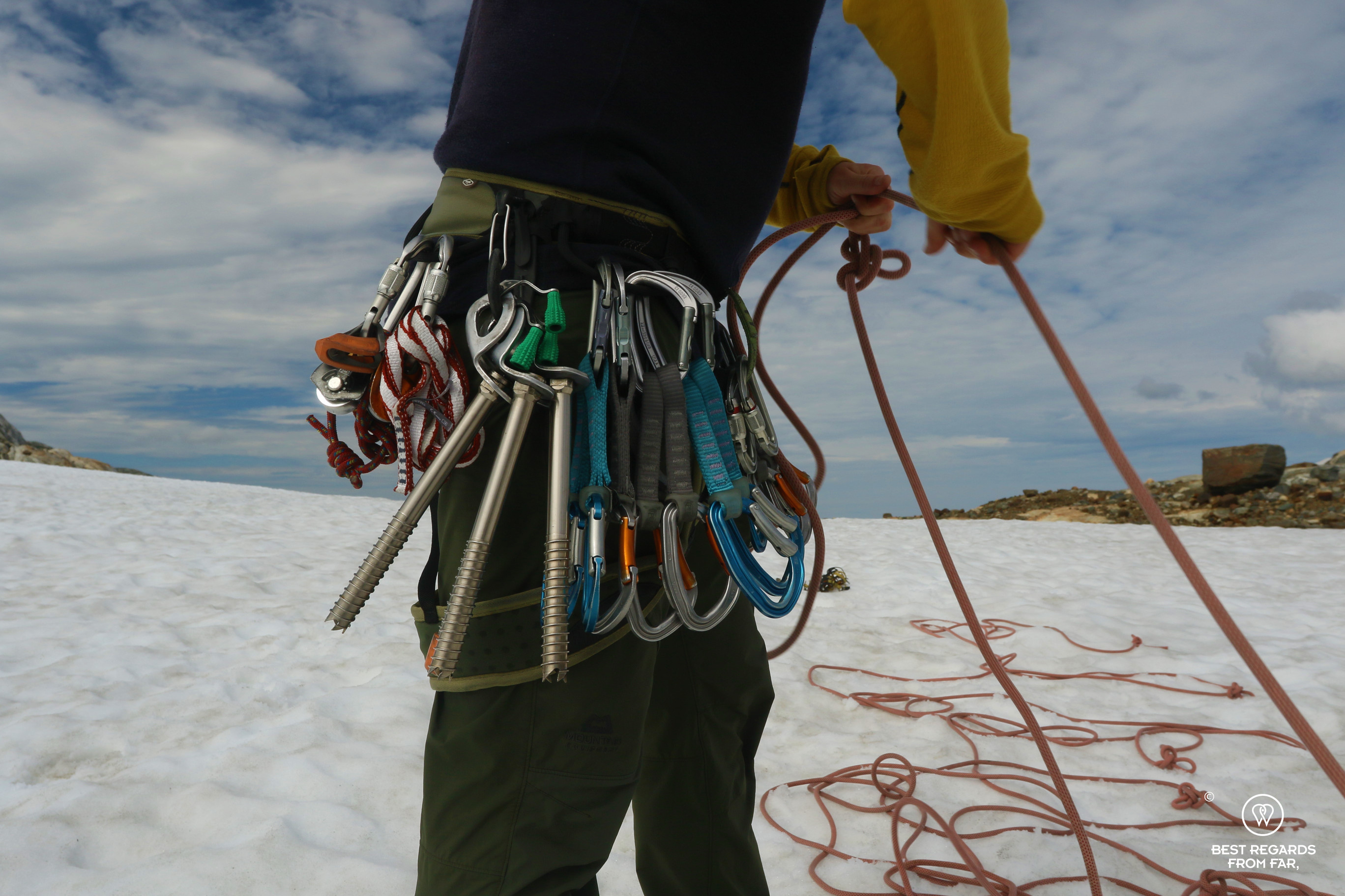 Gear of the guide while he is preparing the rope for the glacier hike