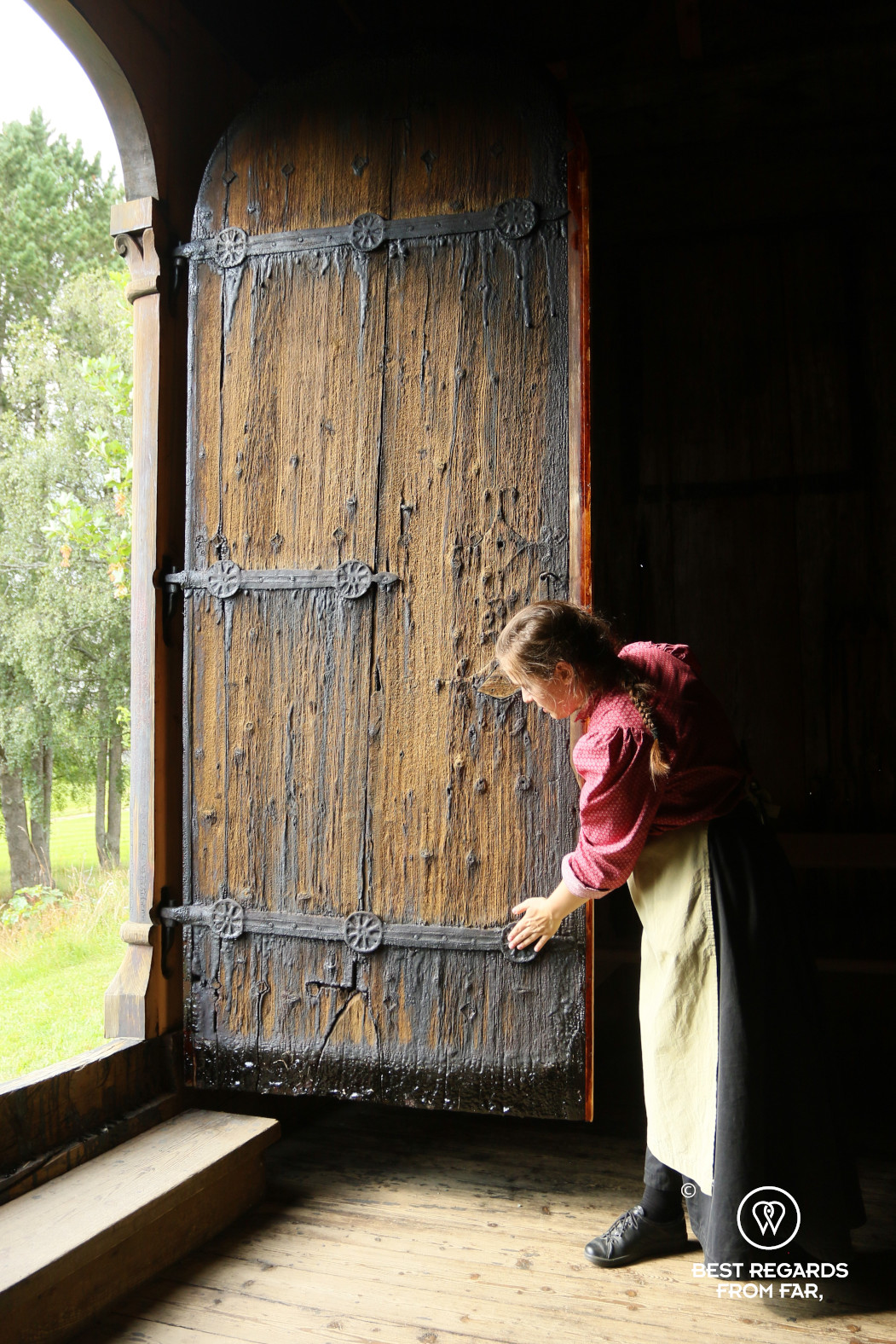 Guide in costume in the stave church of the Trondheim Folk Museum