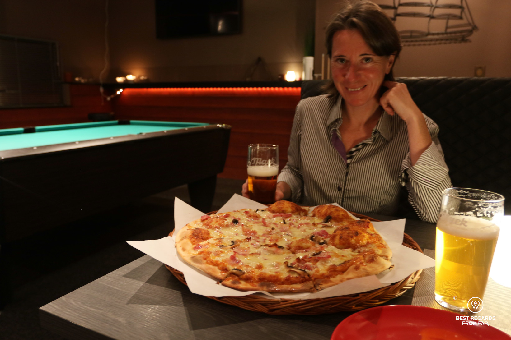 Celebrating reaching Cape Nordkinn over a pizza at Pub Nordkinn, Norway