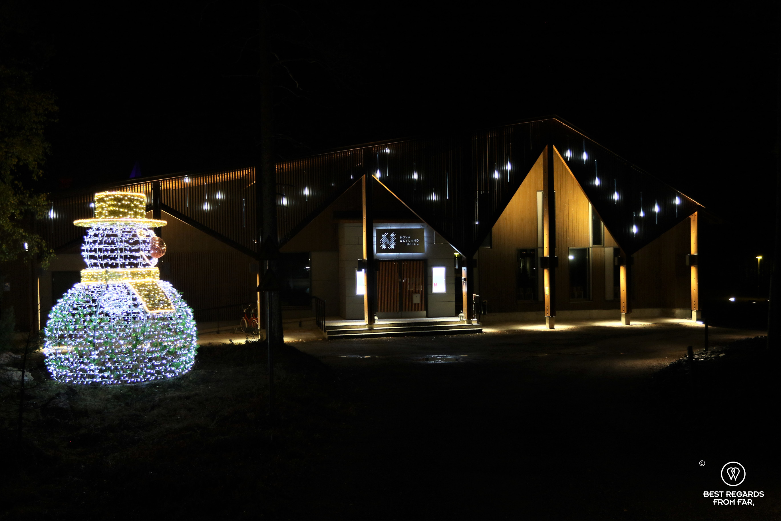 Nova skyland hotel at night with lit snow man in Santa Claus' Village, Finland