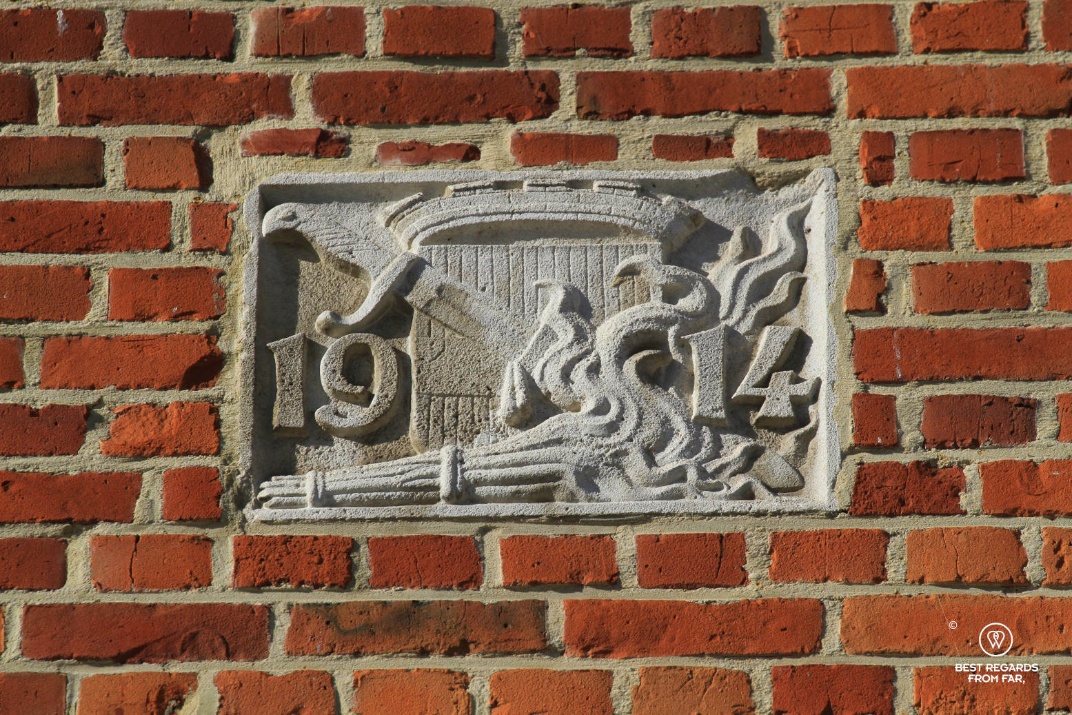 1914 fire plaque on a red brick building in Leuven, Belgium