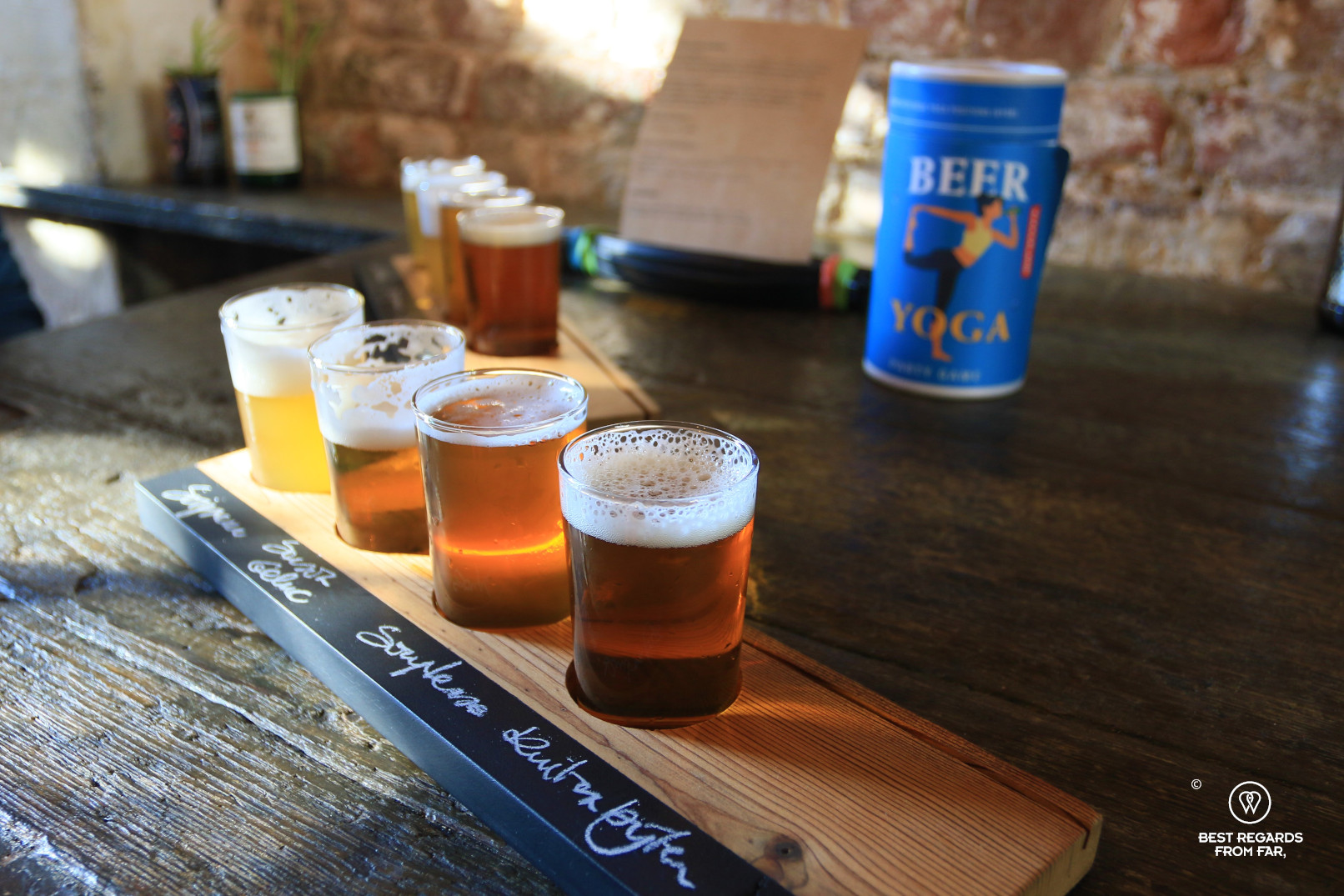 Beer tasting with four glasses on a wooden plate at the independent brewery De Coureur in Leuven, Belgium