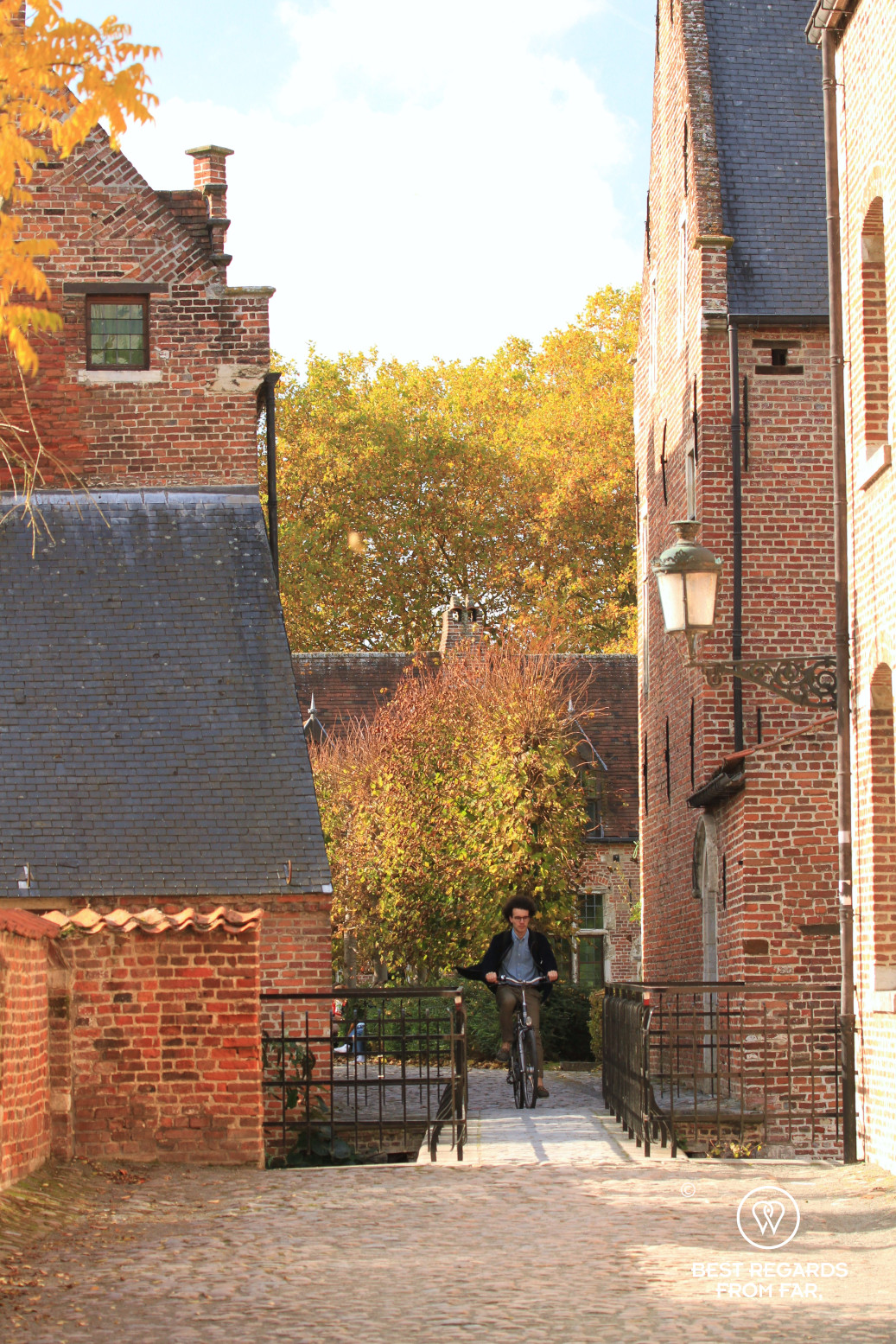 Biker through the Great Béguinage in Leuven, Belgium