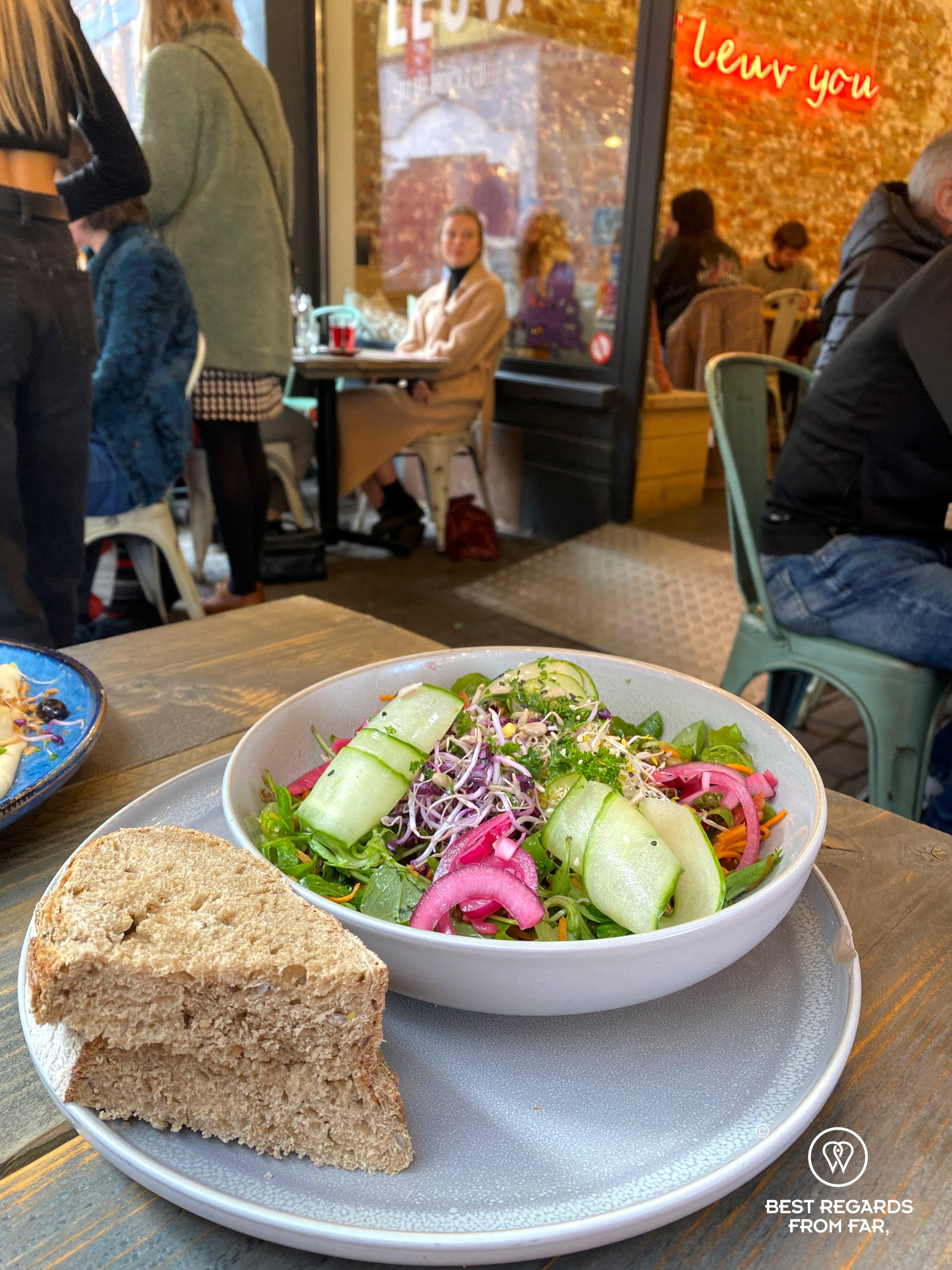 Salad on the terrace with patrons at Bar Leuv, Leuven, Belgium