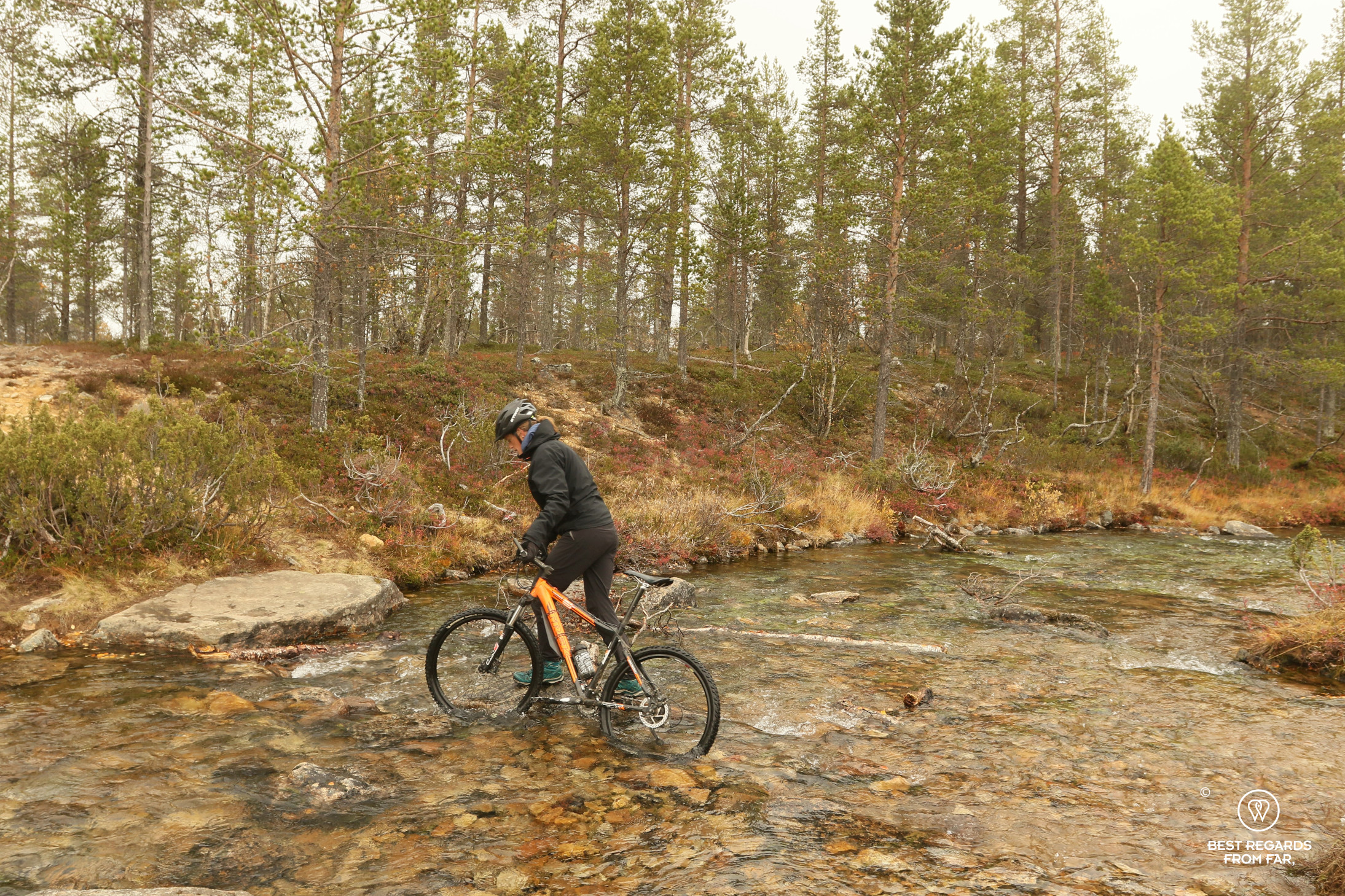 Crossing rivers while mountain biking Lapland around Kakslauttanen