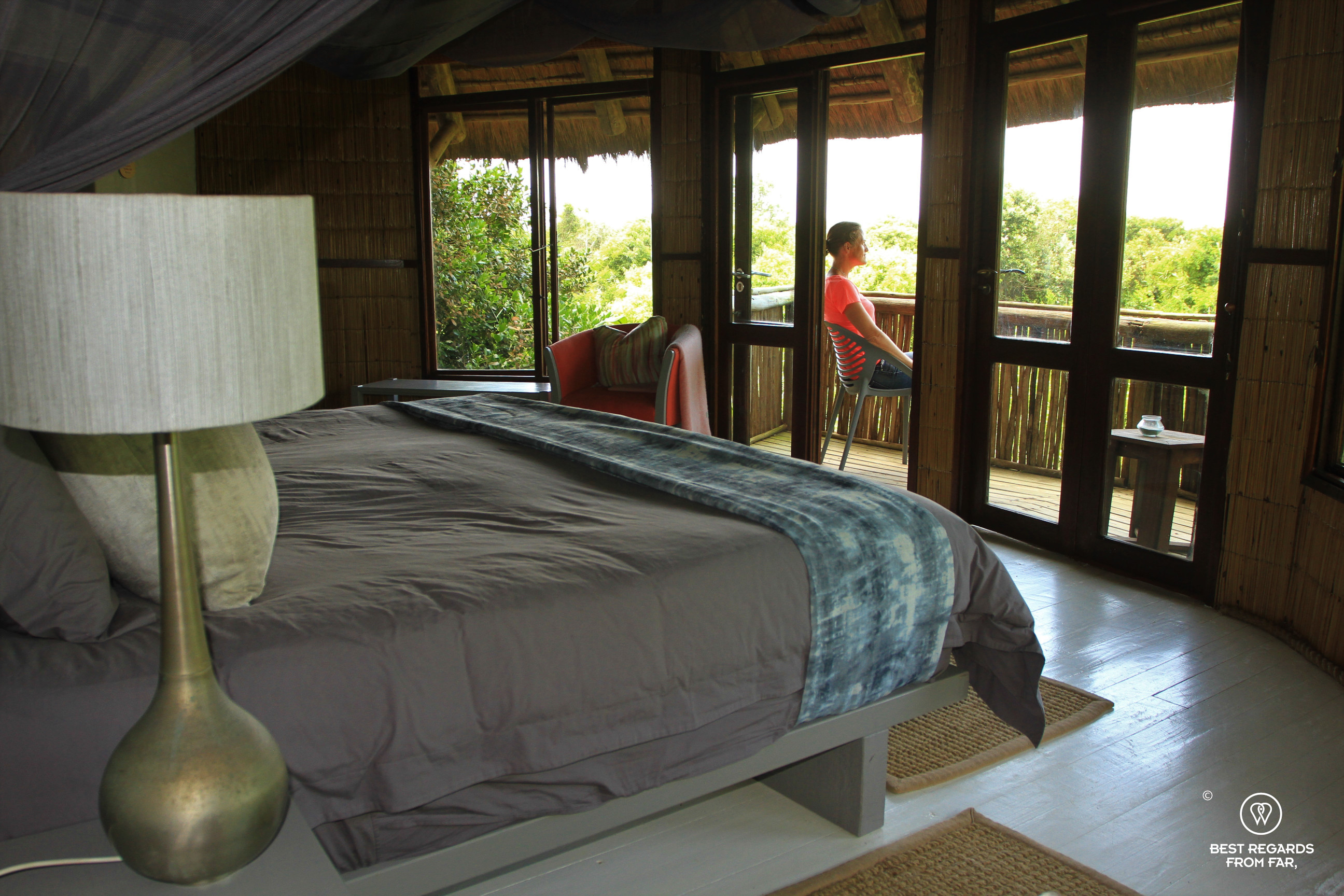 Woman sitting on a balcony of a luxurious lodge