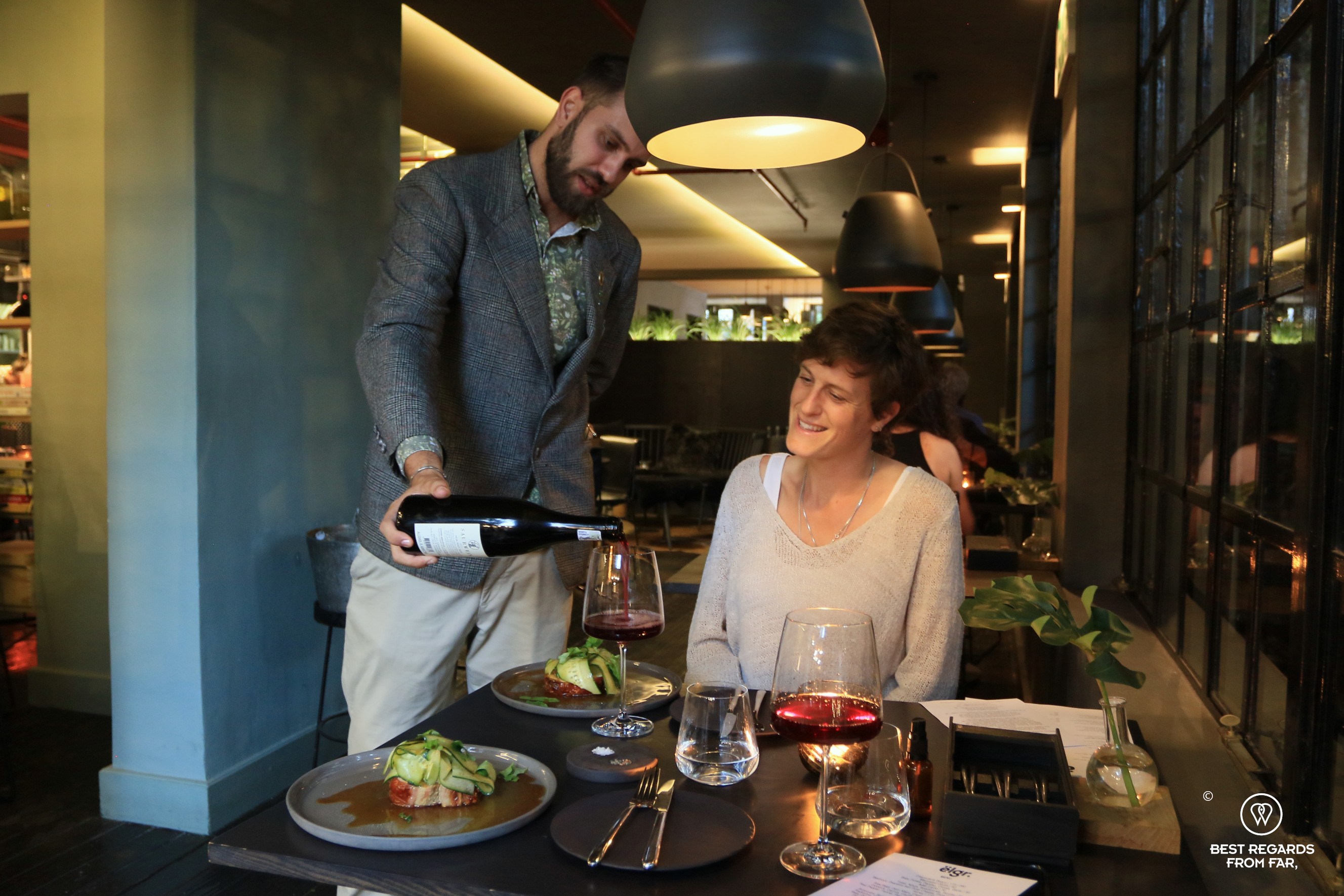 Sommelier pouring a red wine at ëlgr, Cape Town