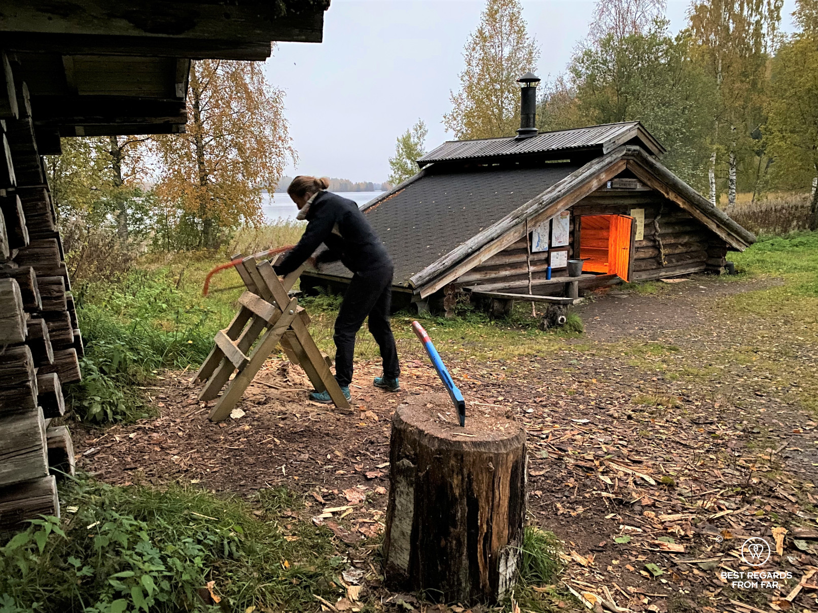 Sawing some wood in by a wilderness hut, Finland