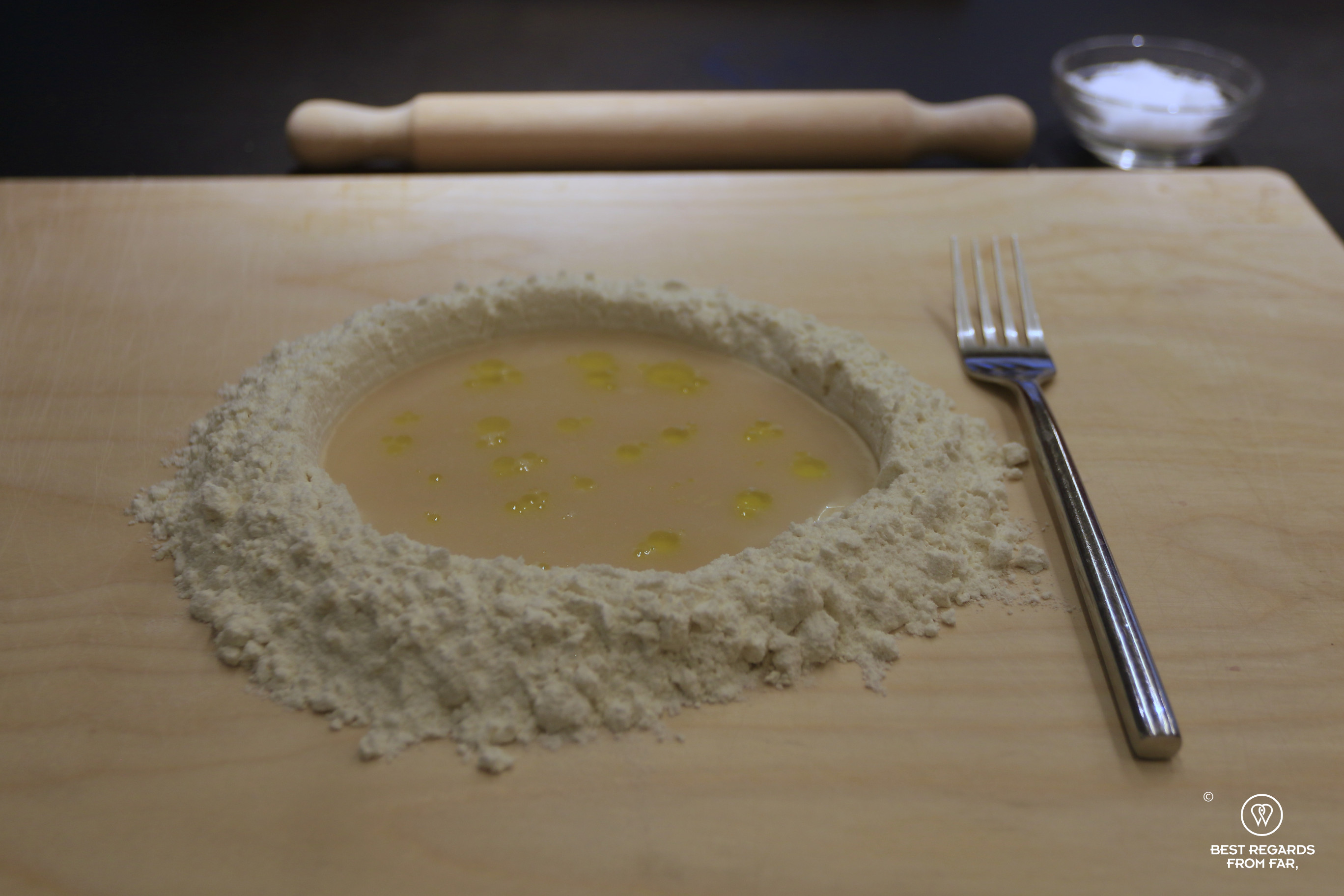 Mixing ingredients for the pizza dough during the cooking class