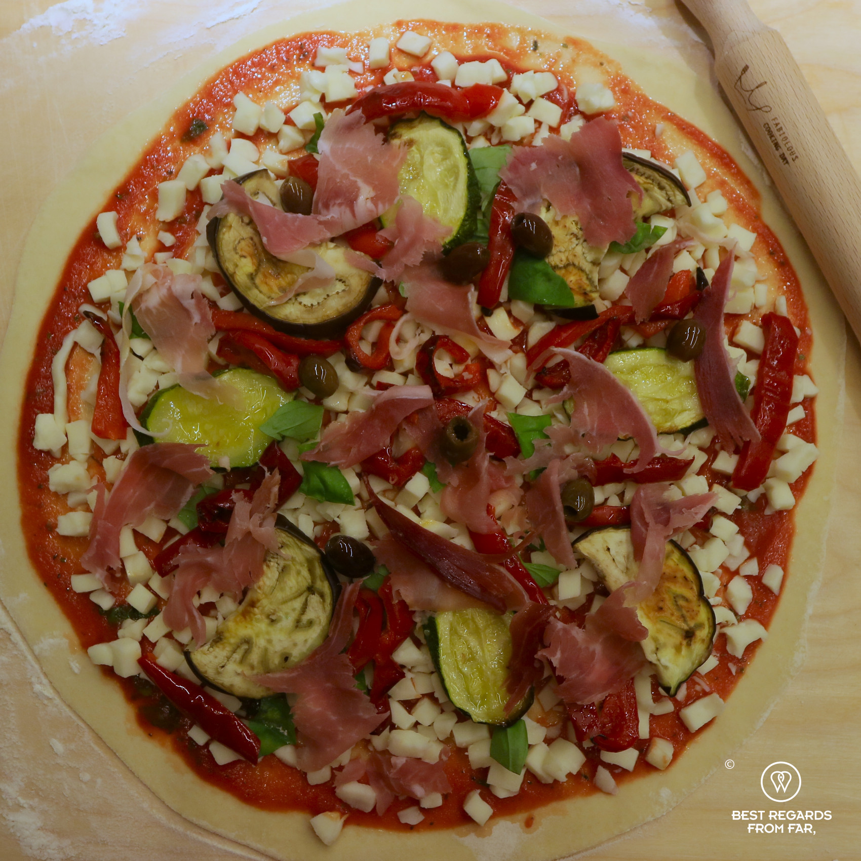 Pizza with its toppings during the cooking class