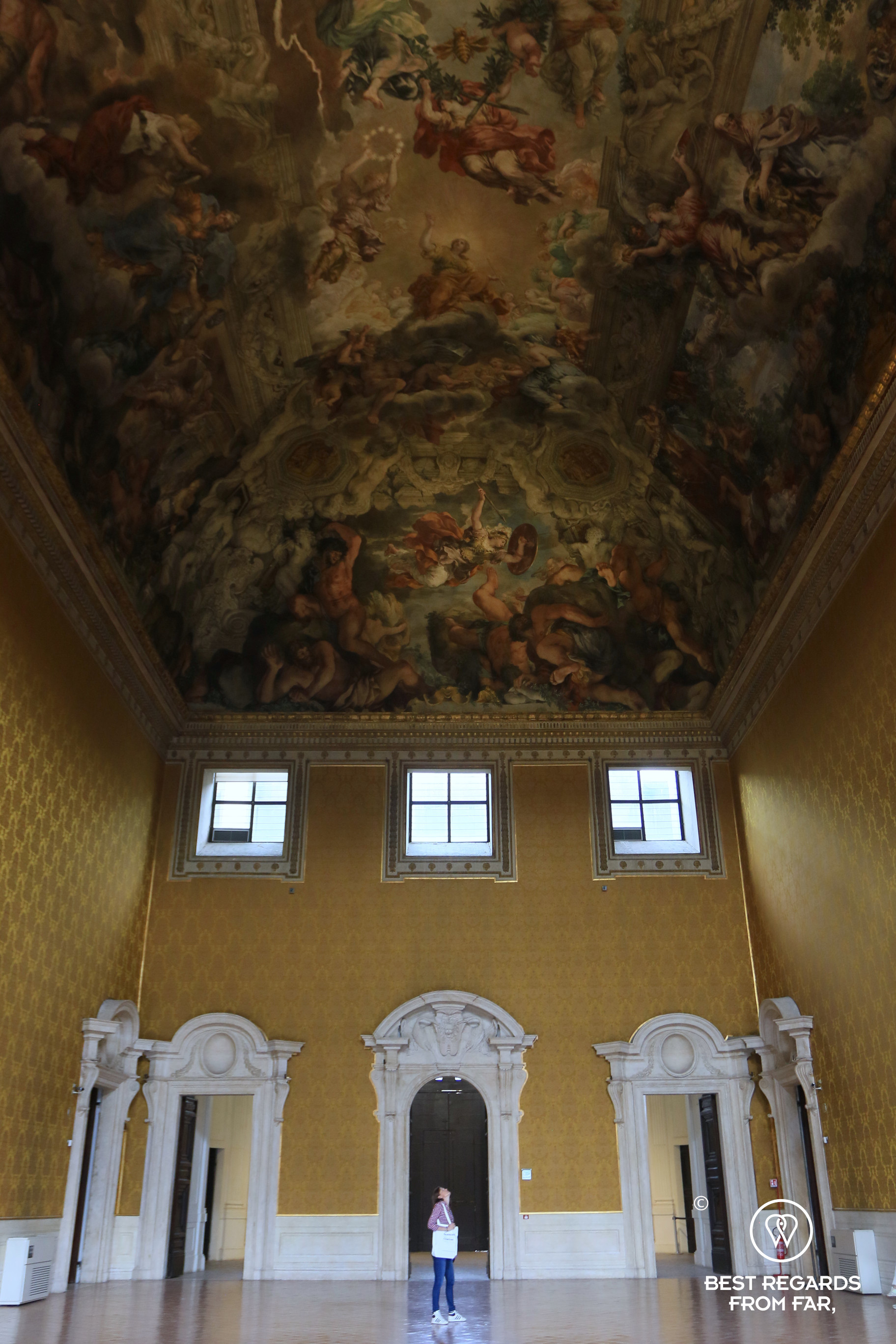 Person standing underneath a gigantic ceiling painting