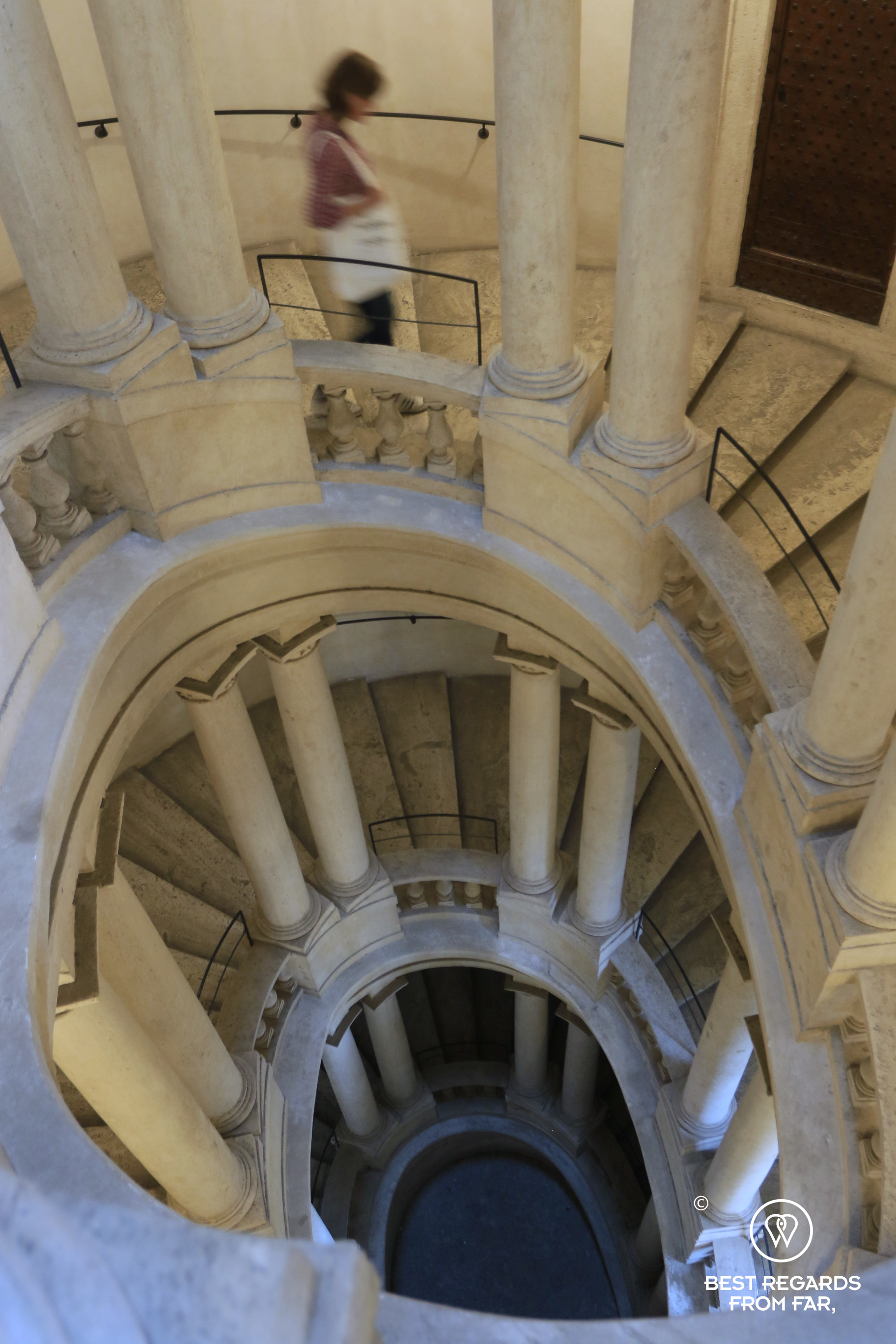 Person walking down the Spiral staircase at the Barberini Palace Rome, Italy