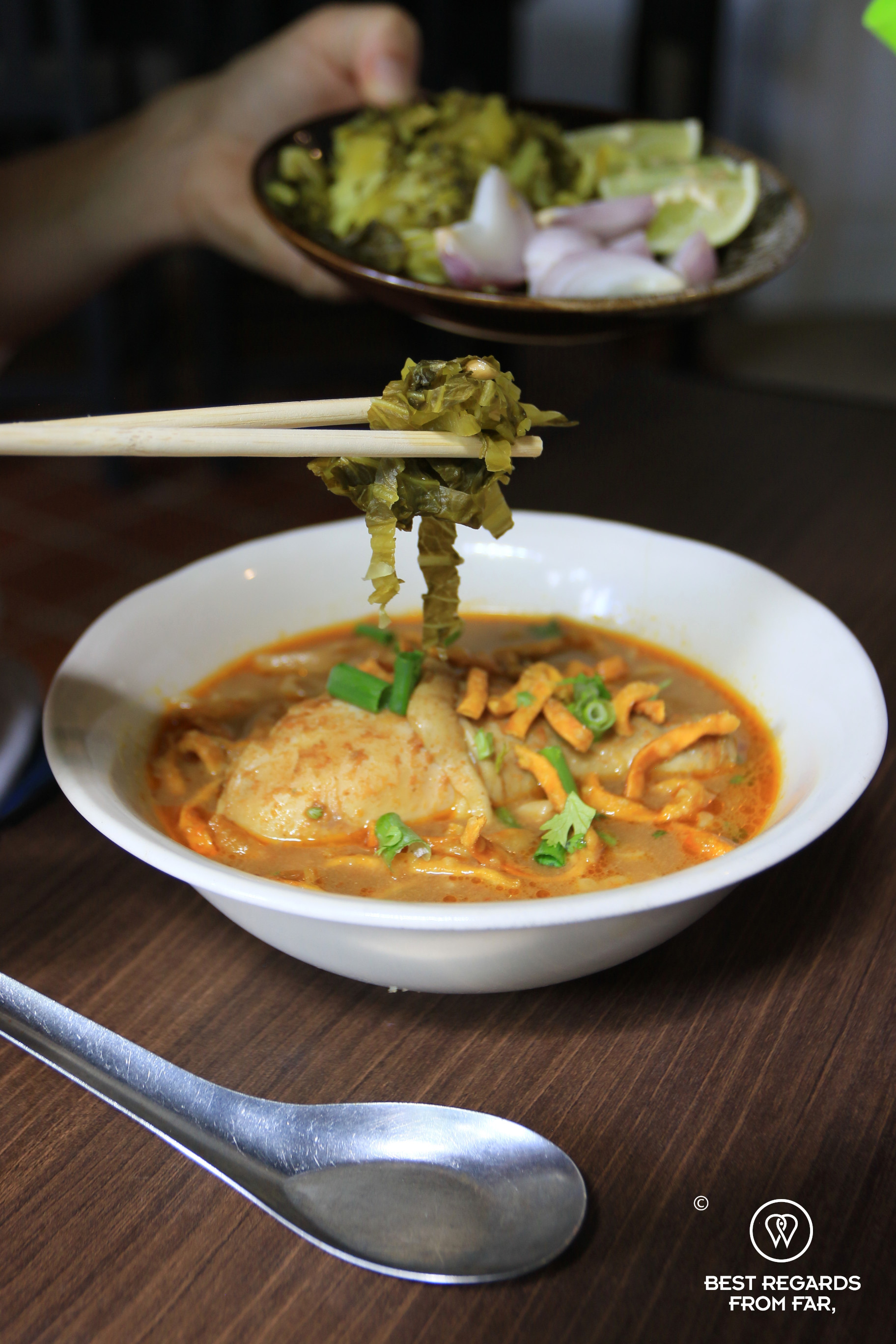 Traditional Khao Soi, boiled and fried egg noodles in coconut curry sauce