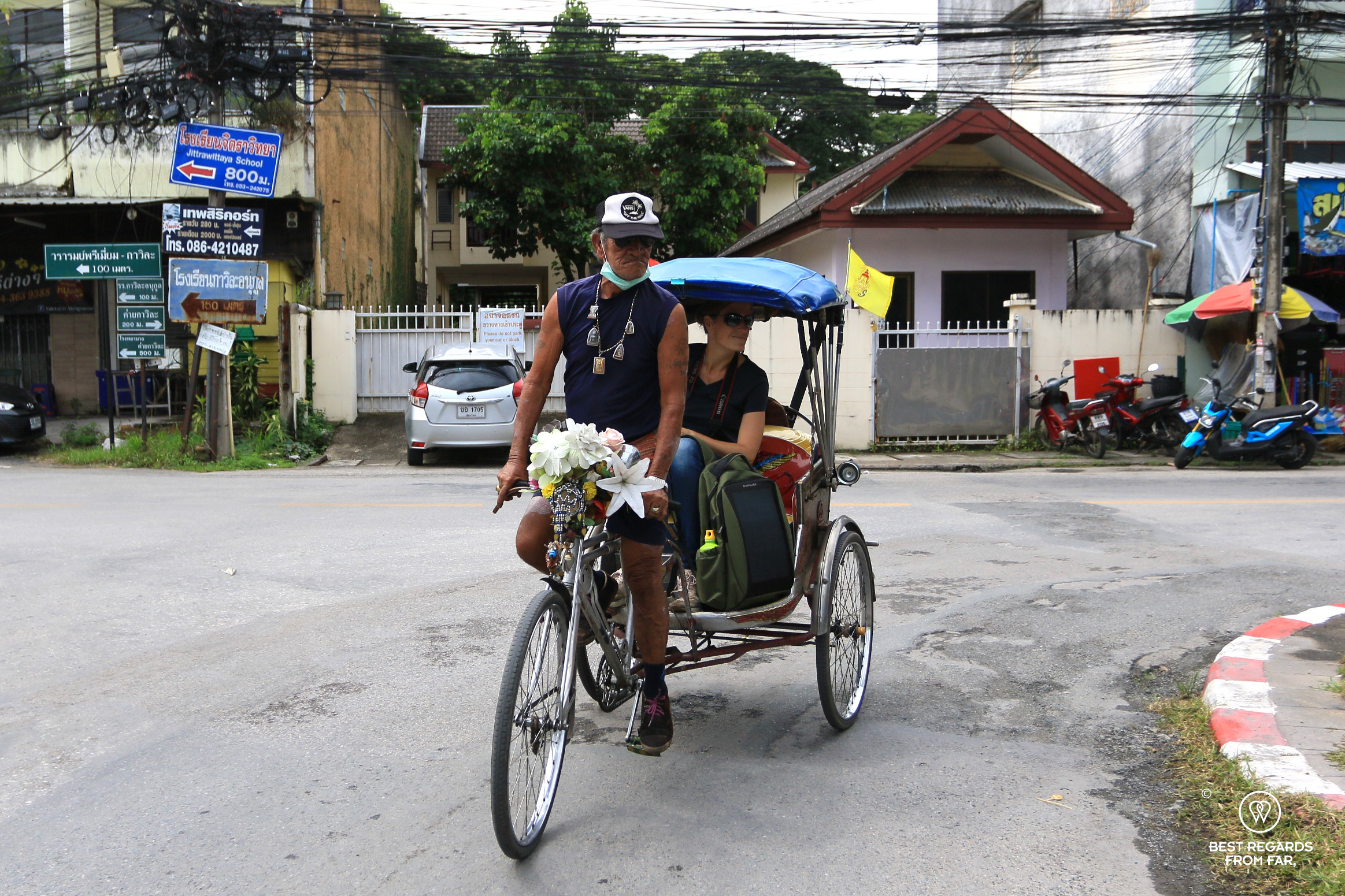 Samlor driver and passenger in the streets of Chiang Mai