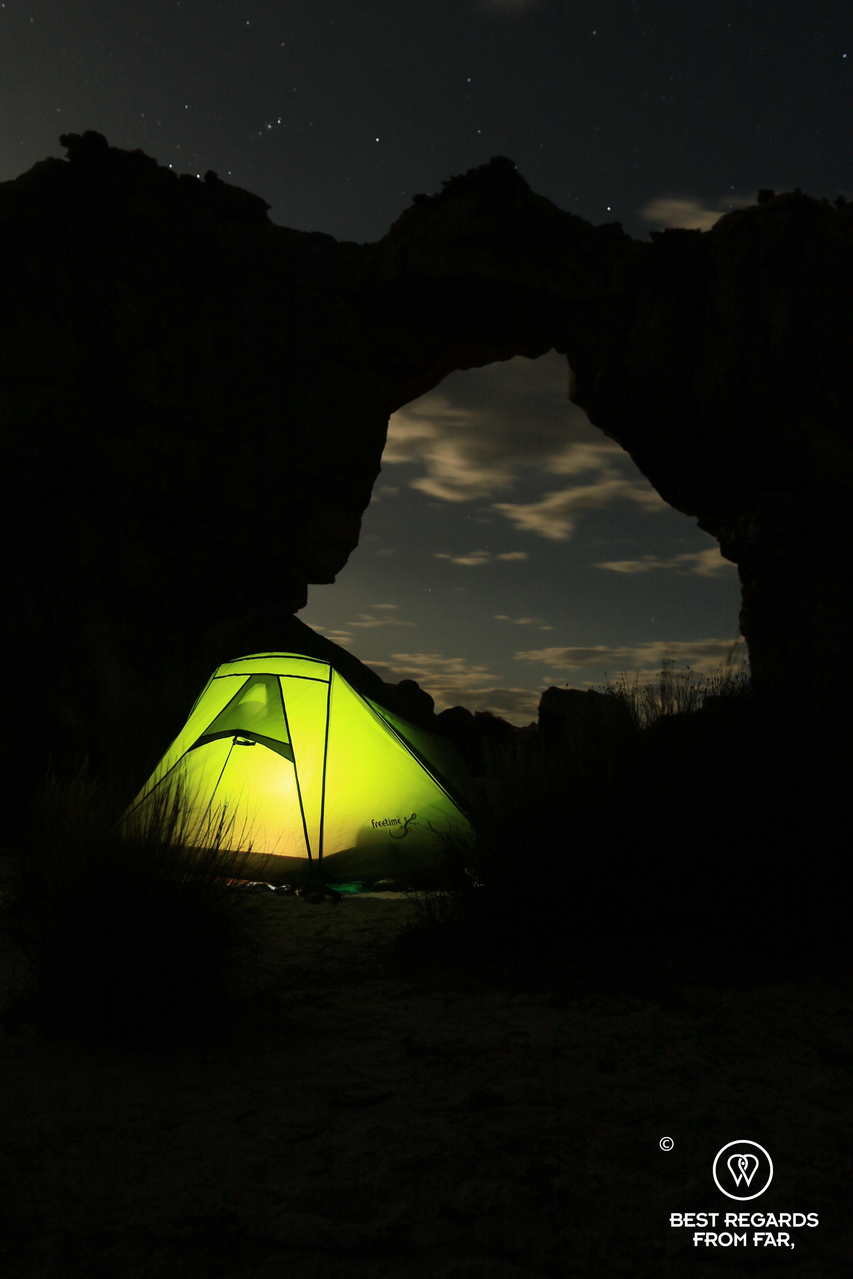 A bivouac with a lit tent at the foot of the Wolfberg Arch, Cederberg, South Africa