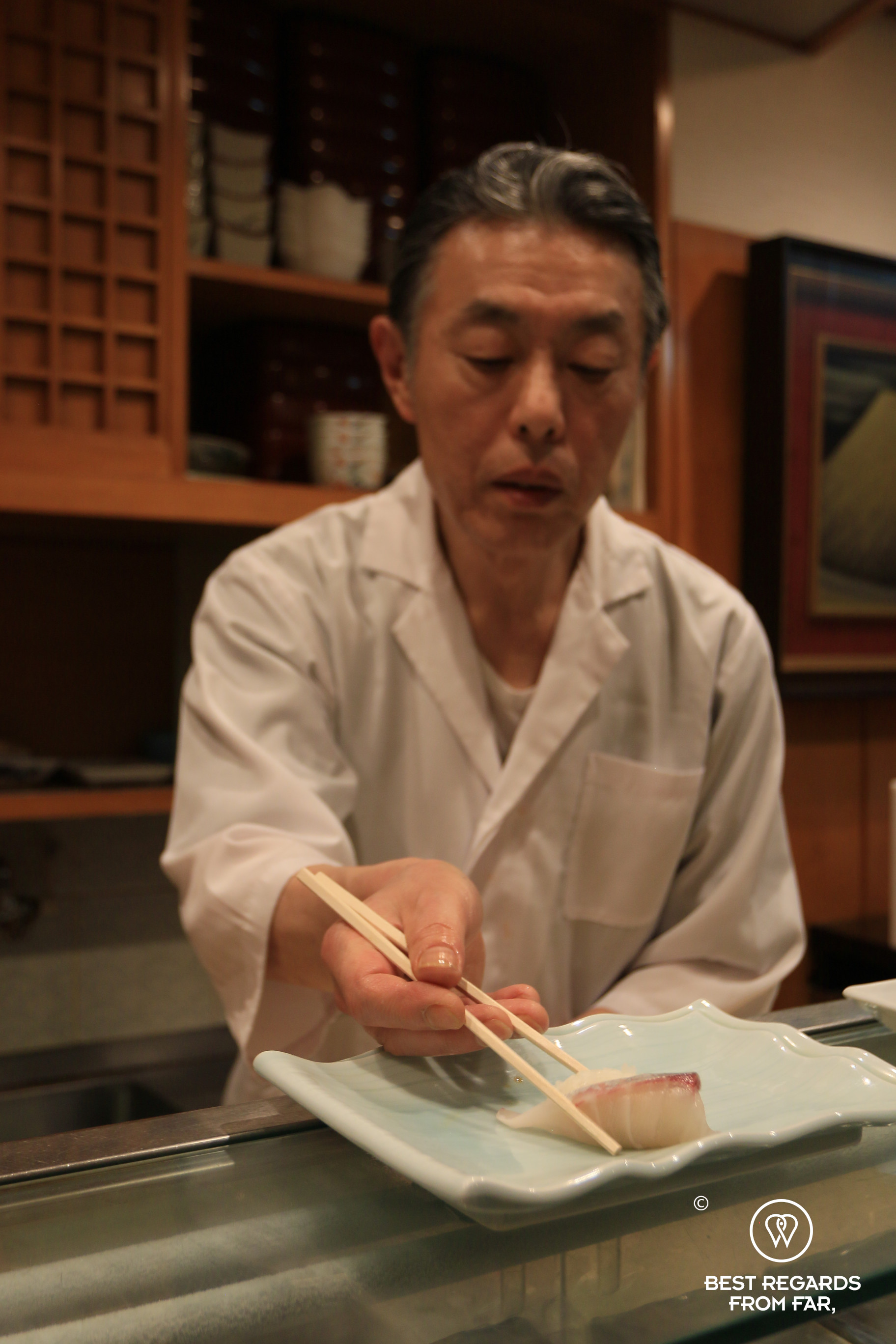 Sushi chef explaining how to handle sushi