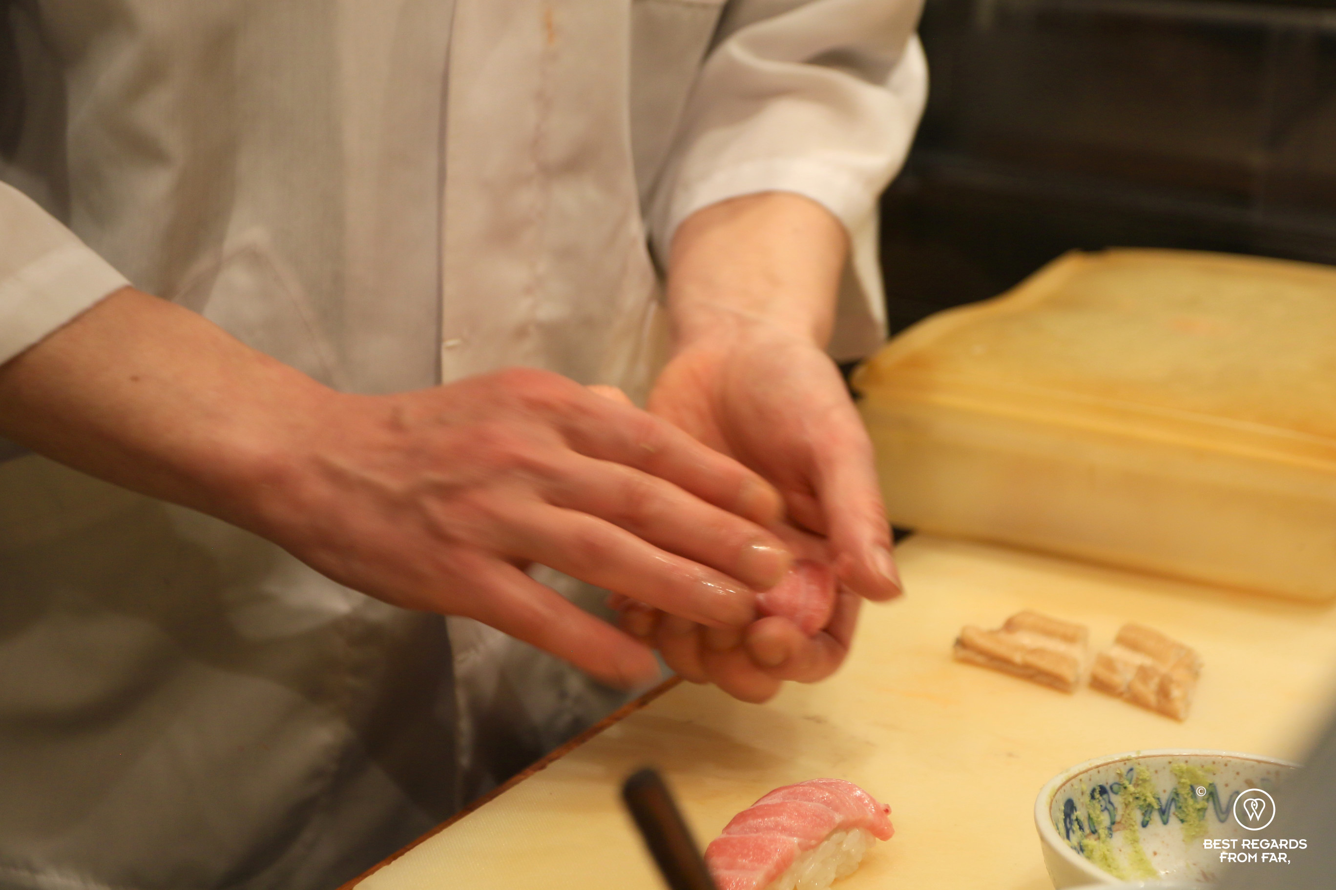 Sushi chef preparing otoro tuna sushi