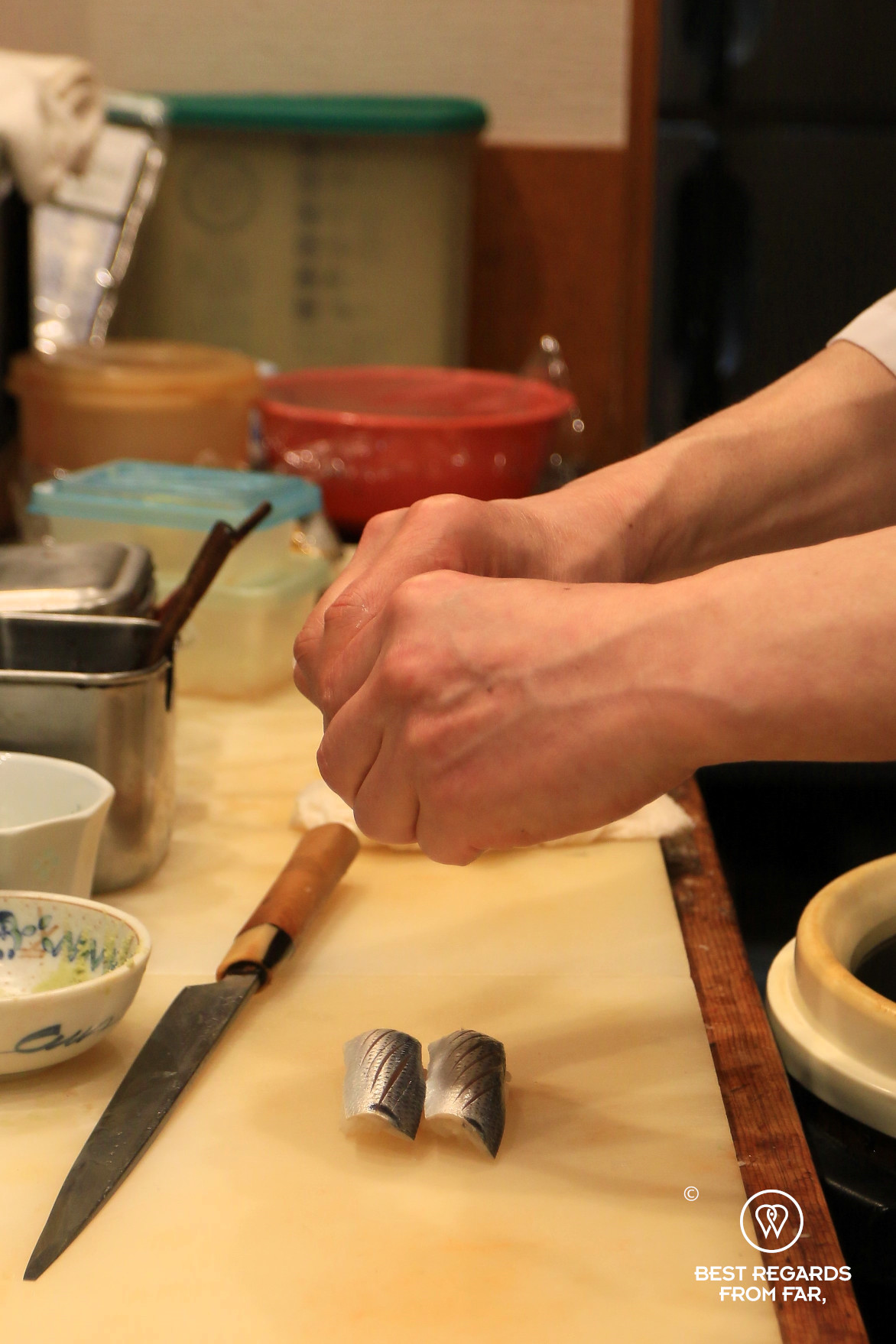 Sushi chef preparing gizzard shad sushi (kohada)